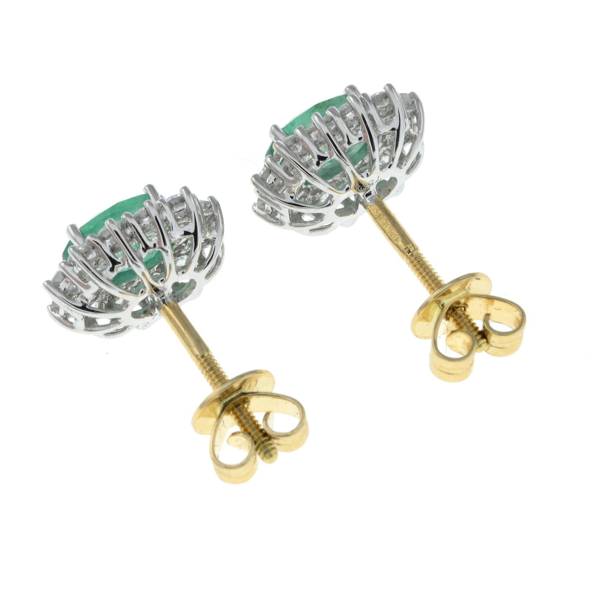 A pair of 18ct gold emerald and brilliant-cut diamond cluster earrings. - Image 2 of 2