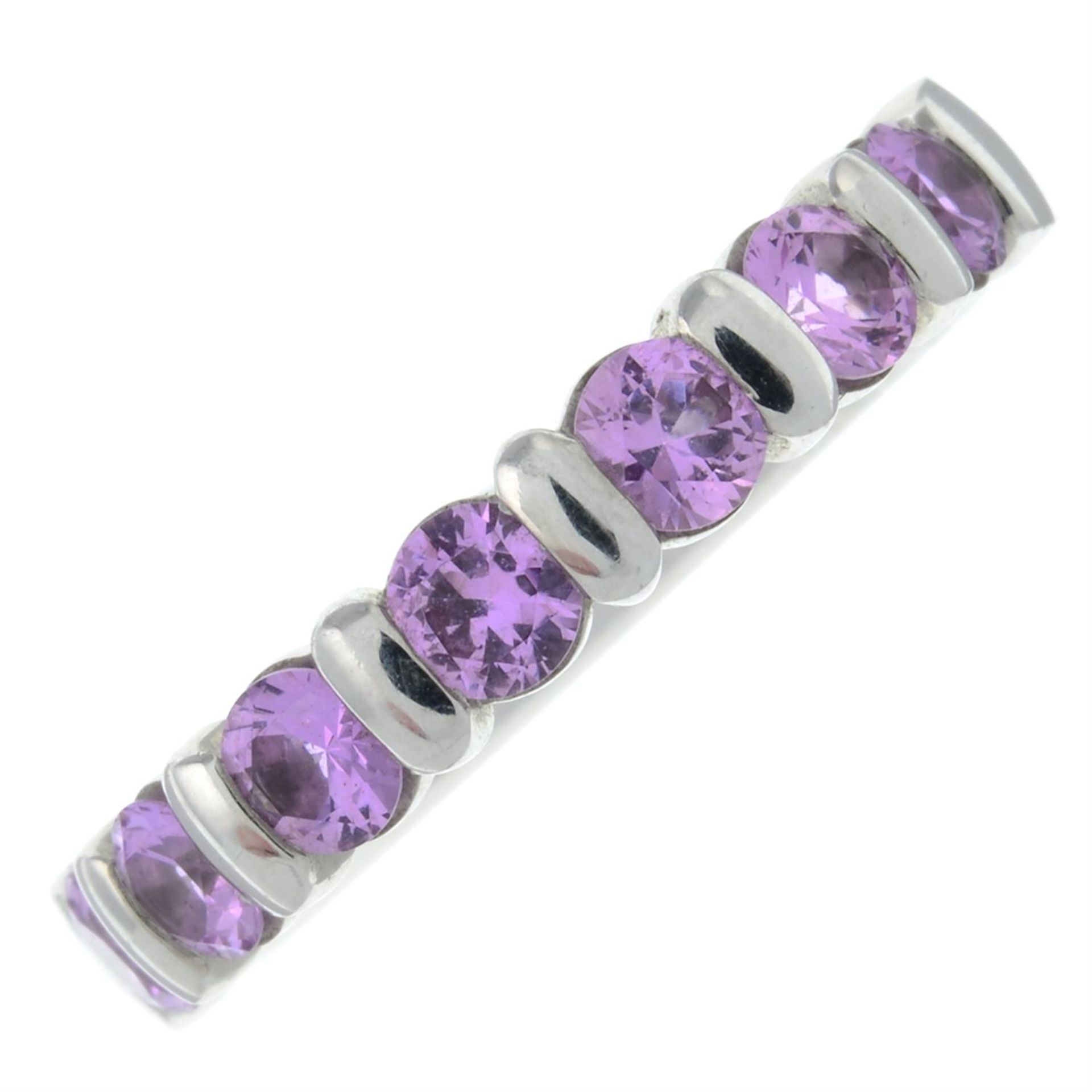 An 18ct gold pink sapphire half eternity ring.