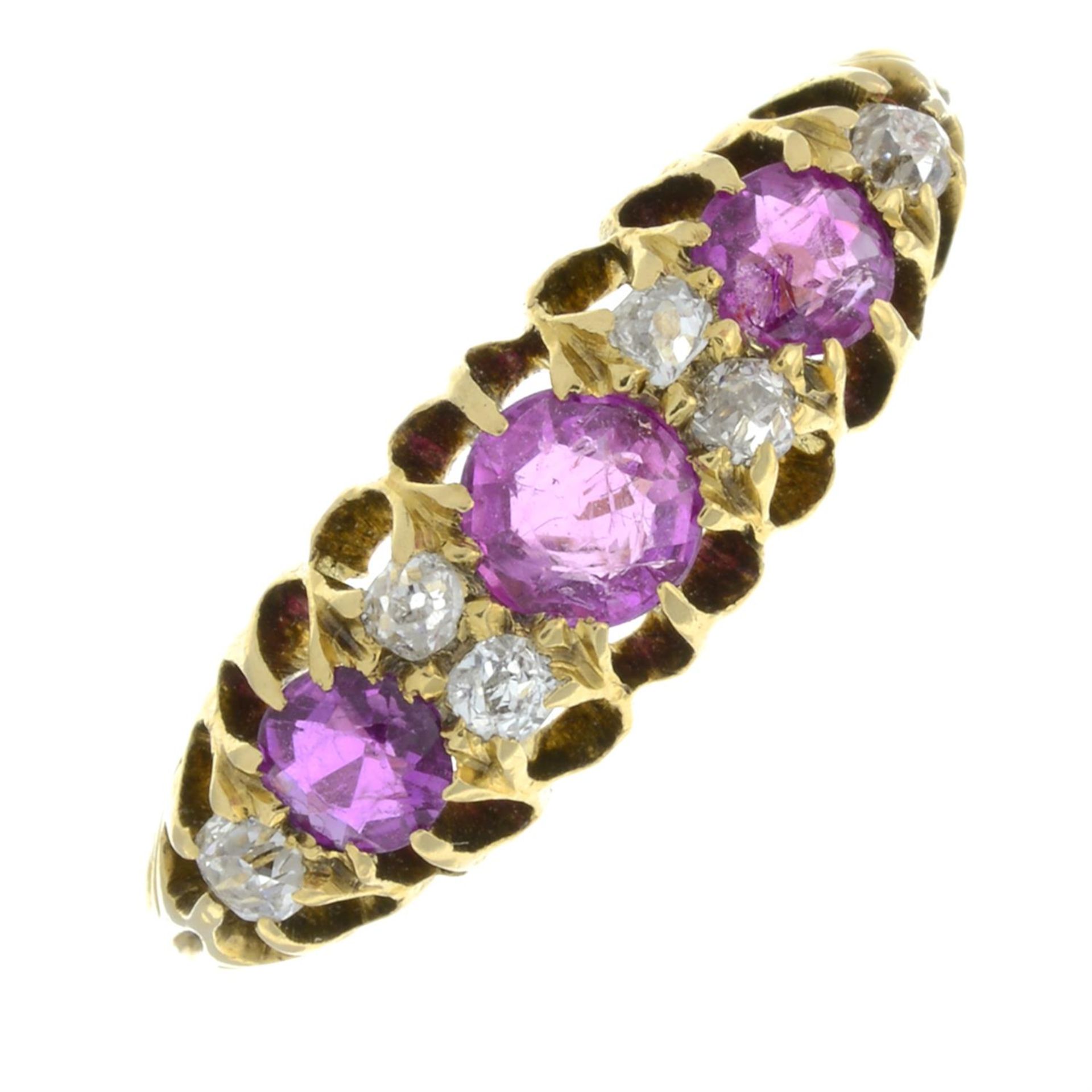 An early 20th century 18ct gold ruby three-stone ring, with old-cut diamond spacers.