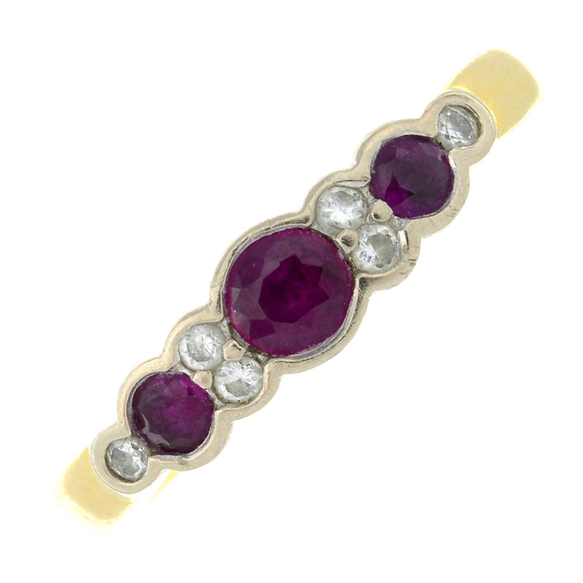 An 18ct gold ruby three-stone ring, with brilliant-cut diamond spacers.