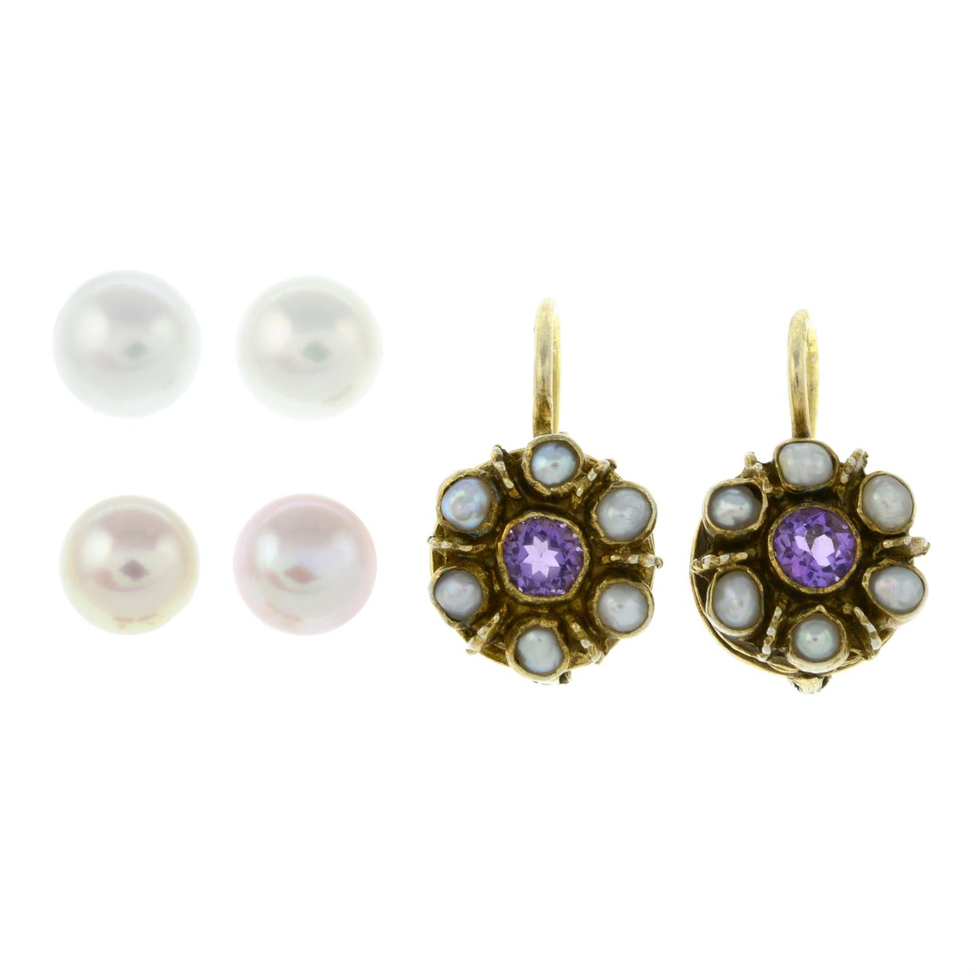 A pair of split pearl and amethyst earrings, and two pair of pearl single-stone earrings.