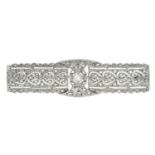 An early 20th century platinum rose and old-cut diamond openwork plaque brooch.