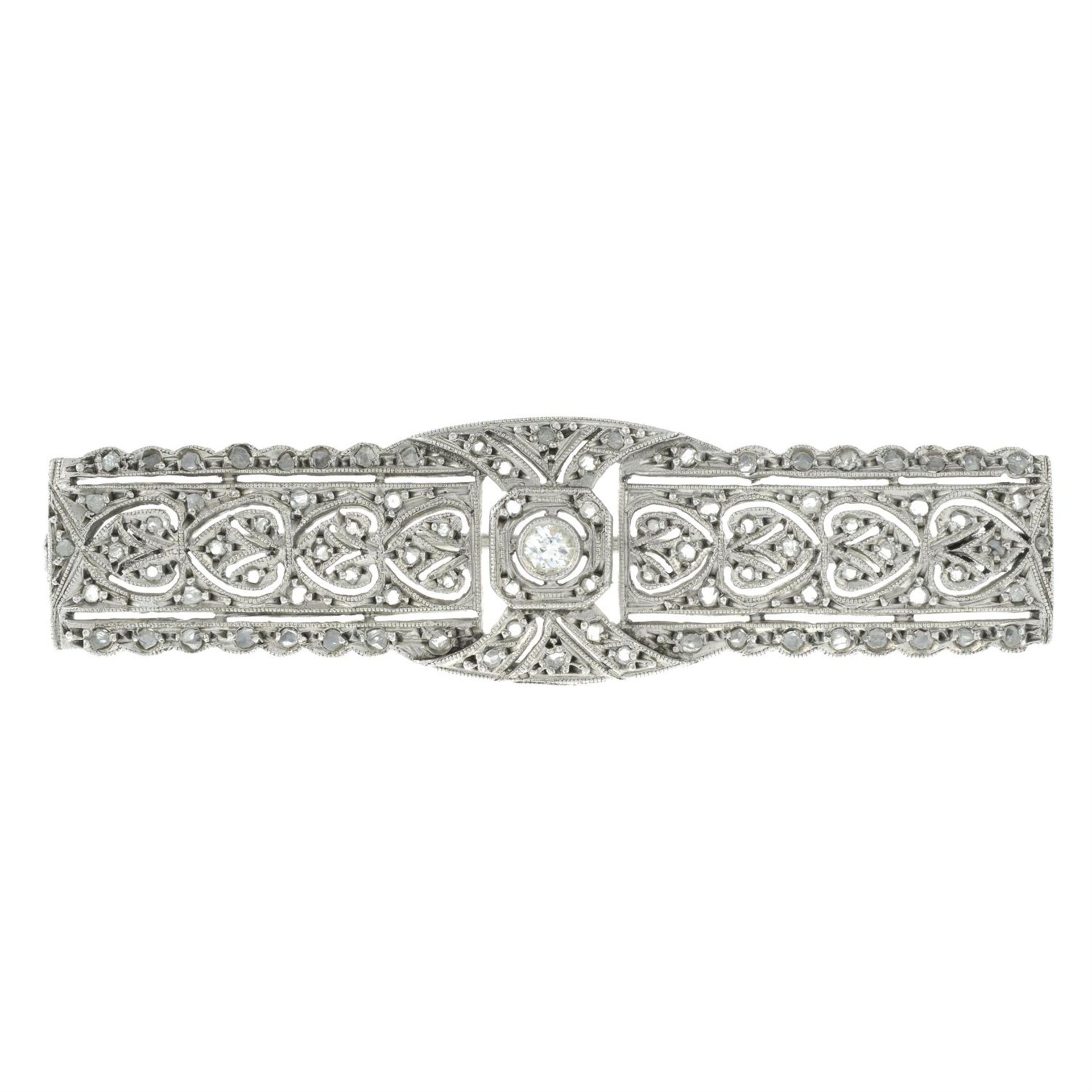 An early 20th century platinum rose and old-cut diamond openwork plaque brooch.