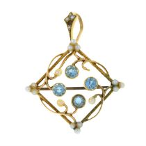 An early 20th century 15ct gold blue zircon, split pearl and seed pearl openwork pendant.