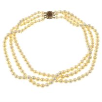 A 1960s cultured pearl three-row necklace, with 9ct gold synthetic ruby clasp.
