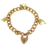 A 9ct gold bracelet, with three suspended charms and heart-shape padlock clasp.