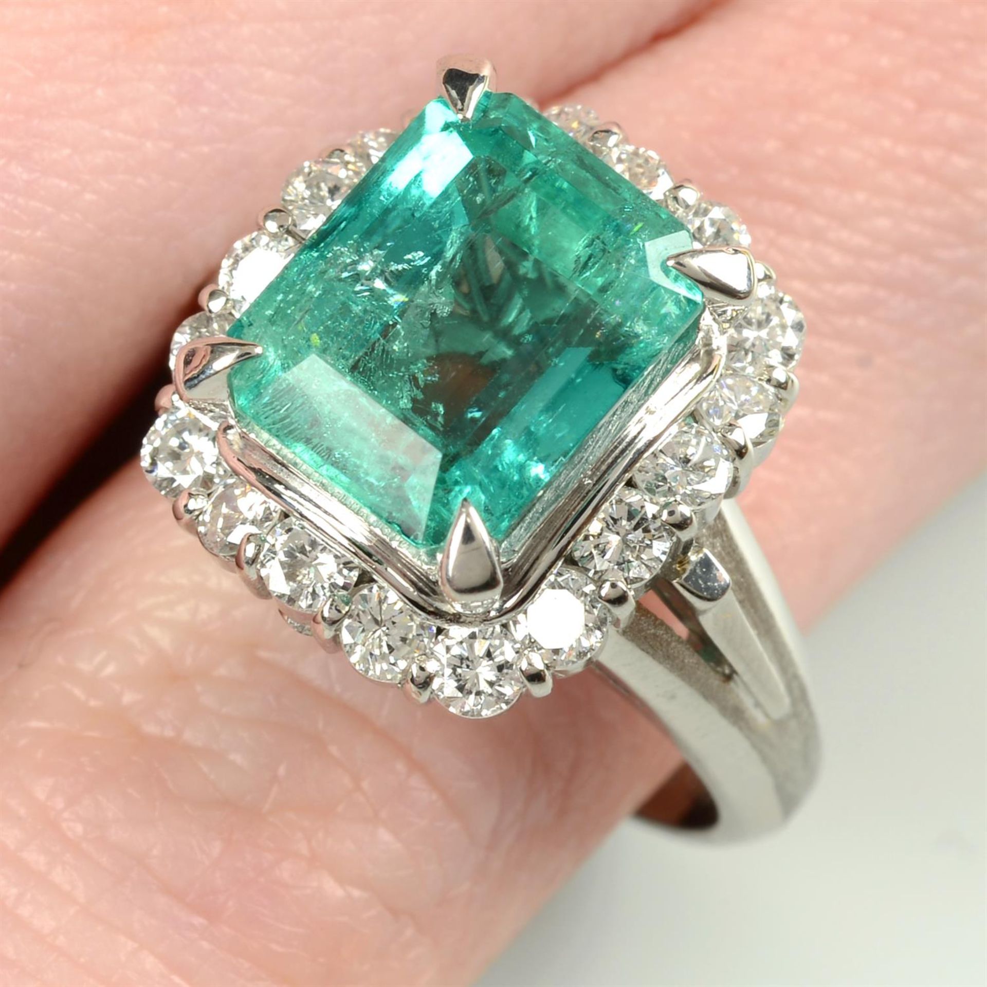 A Colombian emerald and brilliant-cut diamond cluster ring.