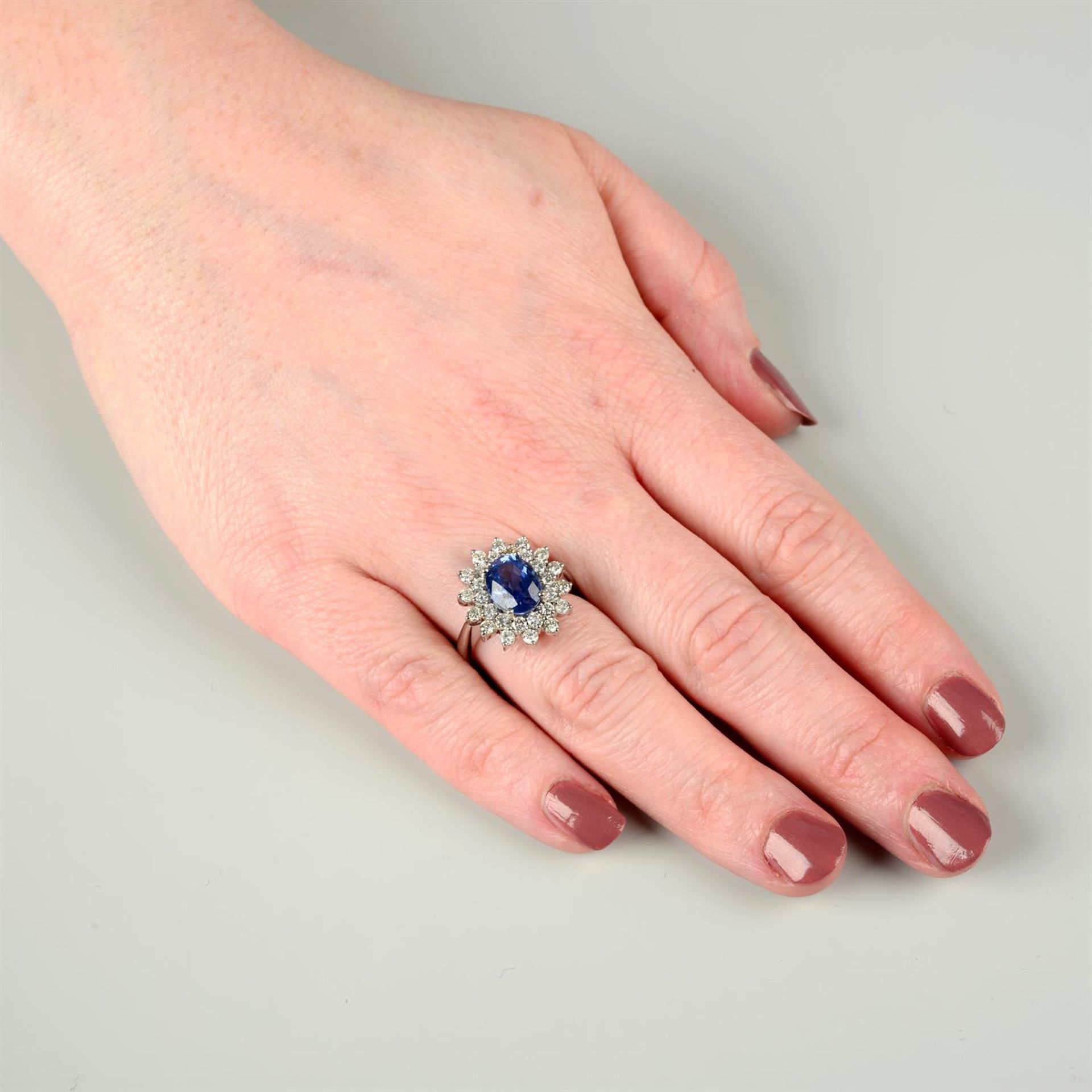 An 18ct gold brilliant-cut diamond and sapphire cluster ring. - Image 5 of 5