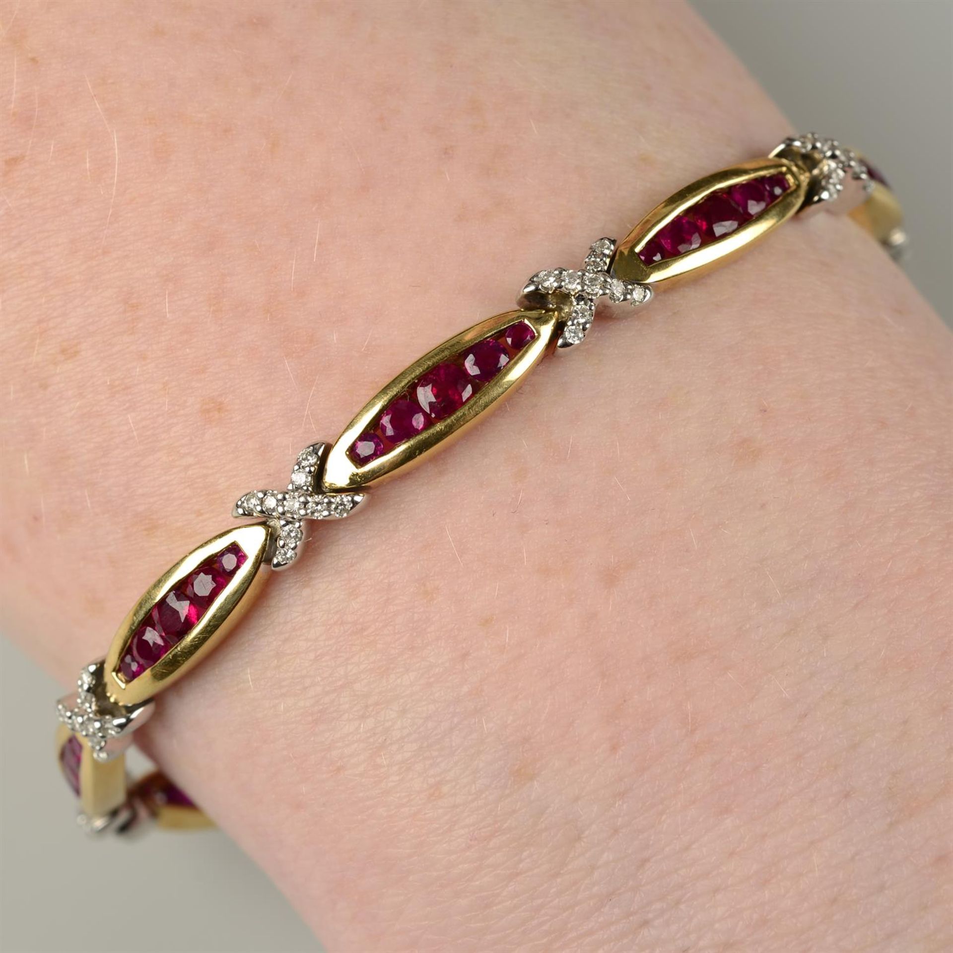 A bi-colour 18ct gold ruby and diamond bracelet.