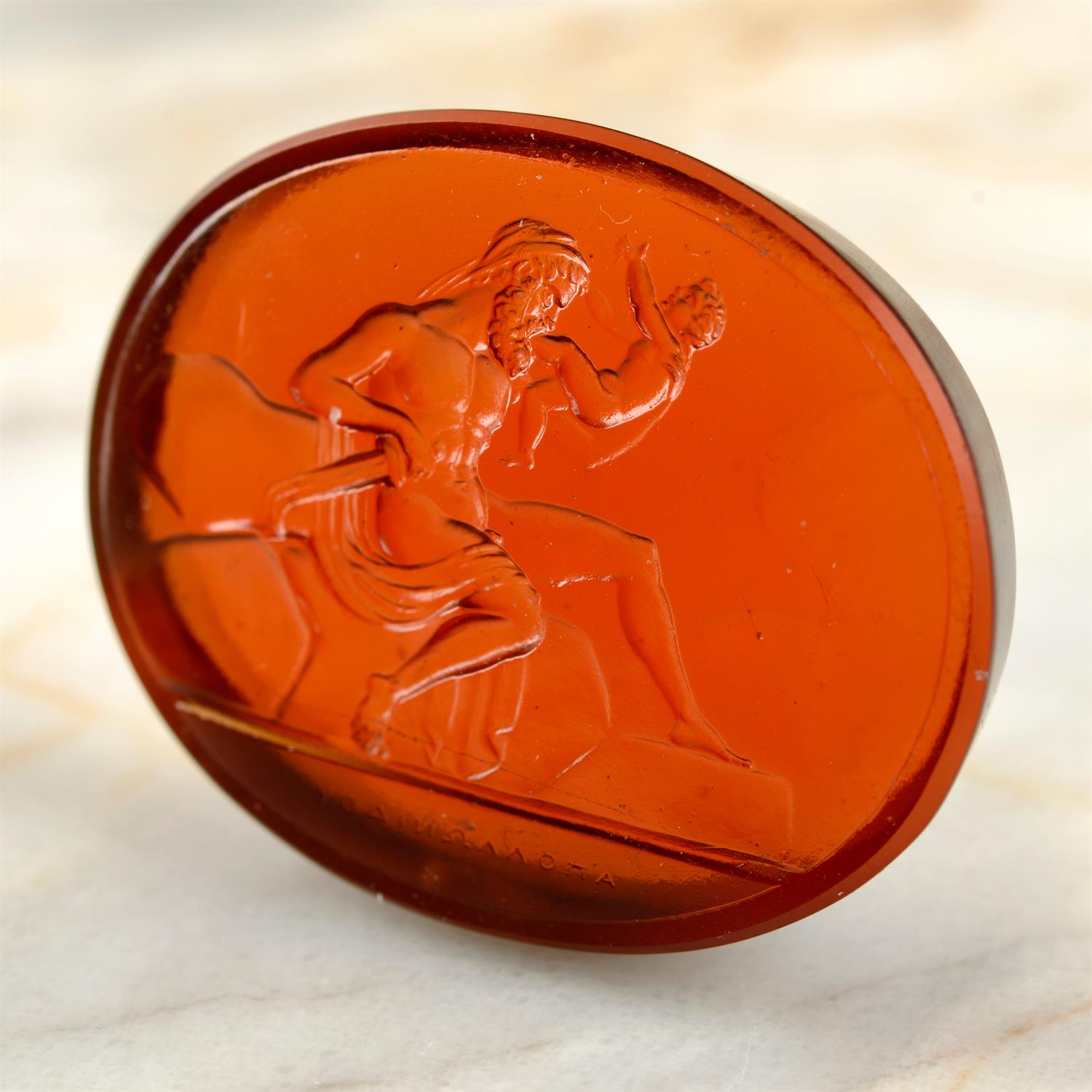 A Georgian glass intaglio, depicting Kronos, harpe in hand, devouring one of his children.