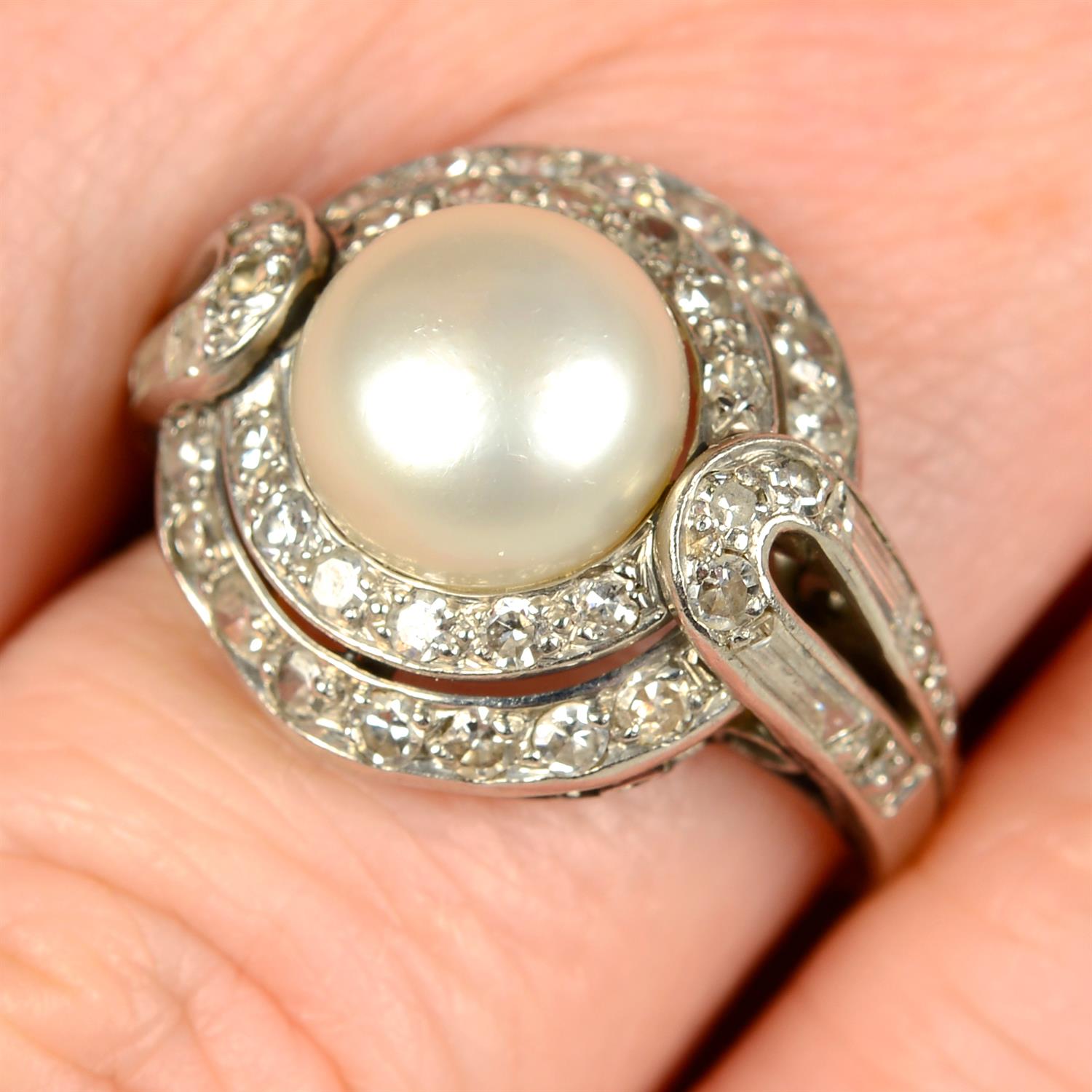 An early to mid 20th century platinum pearl, single and baguette-cut diamond dress ring.