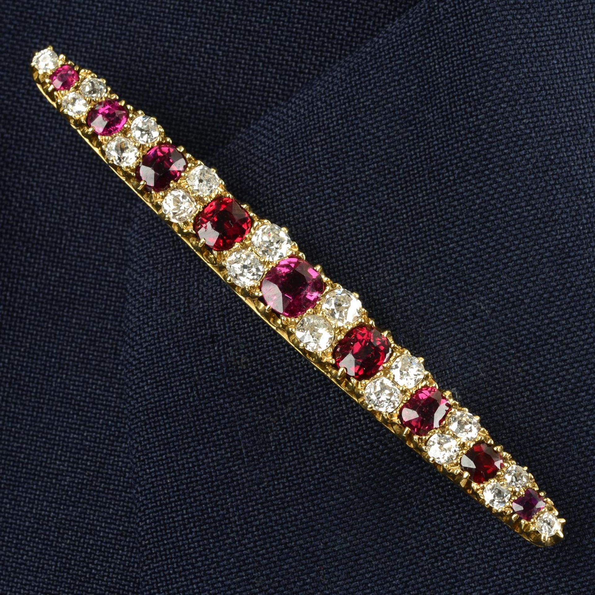 An early 20th century 18ct gold red spinel and old-cut diamond bar brooch.