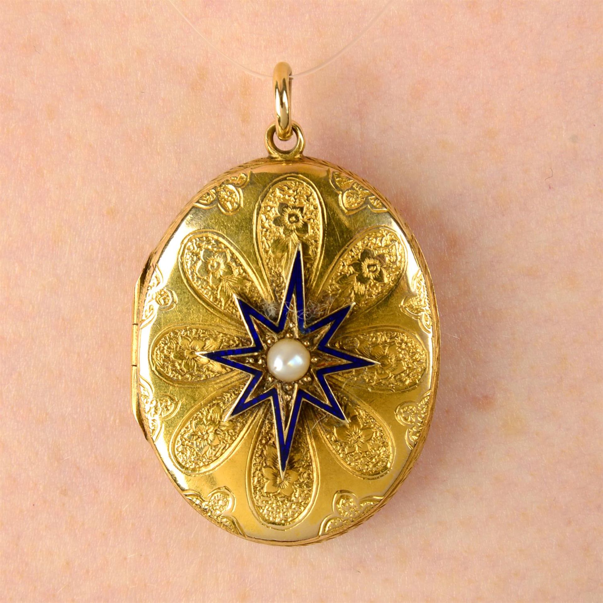 A late Victorian 18ct gold floral engraved locket, with split pearl and blue enamel star highlight.