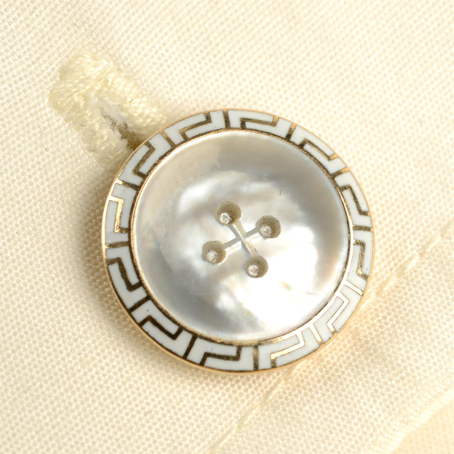 A pair of early 20th century 14ct gold carved mother-of-pearl and white enamel button motif