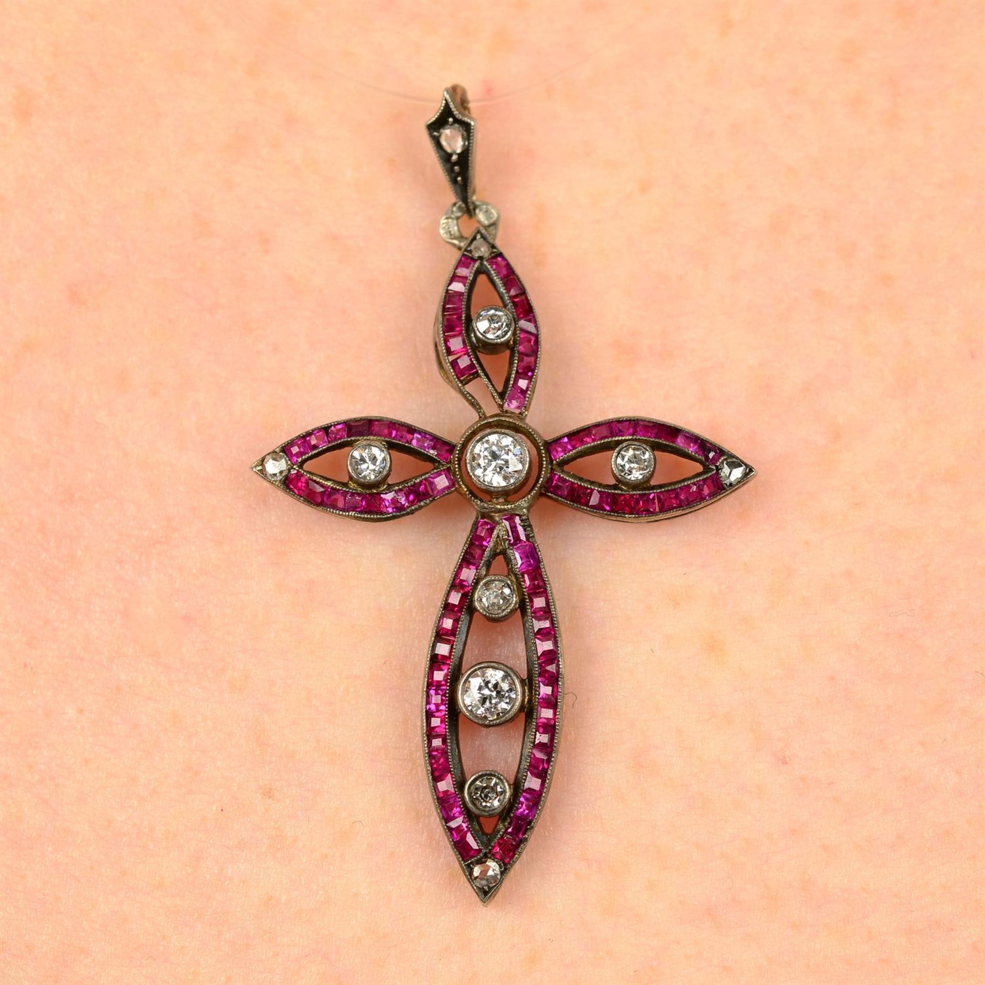 An early 20th century silver and gold synthetic ruby and diamond cross pendant.