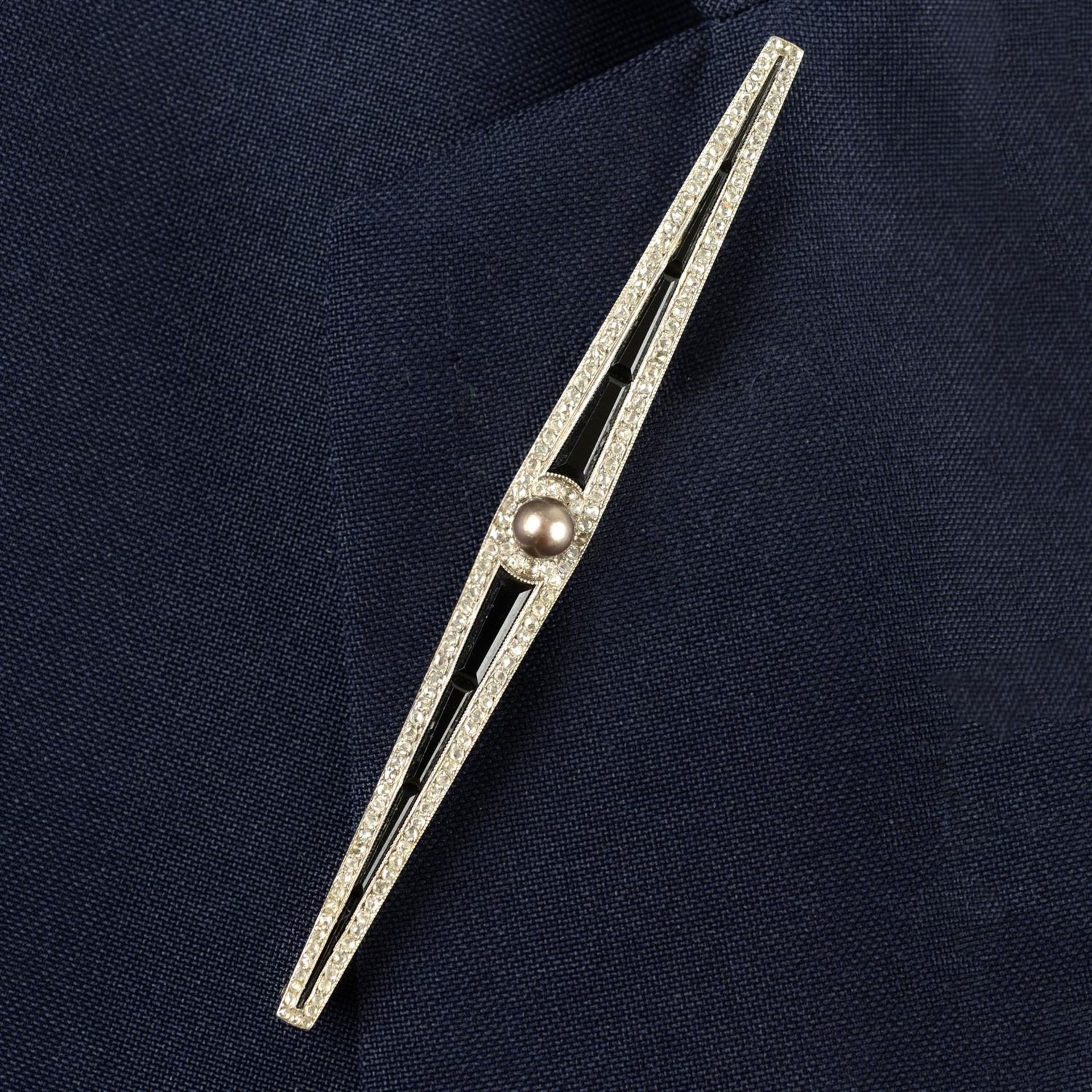 An Art Deco platinum and gold rose-cut diamond, calibre-cut onyx and mabe pearl bar brooch.