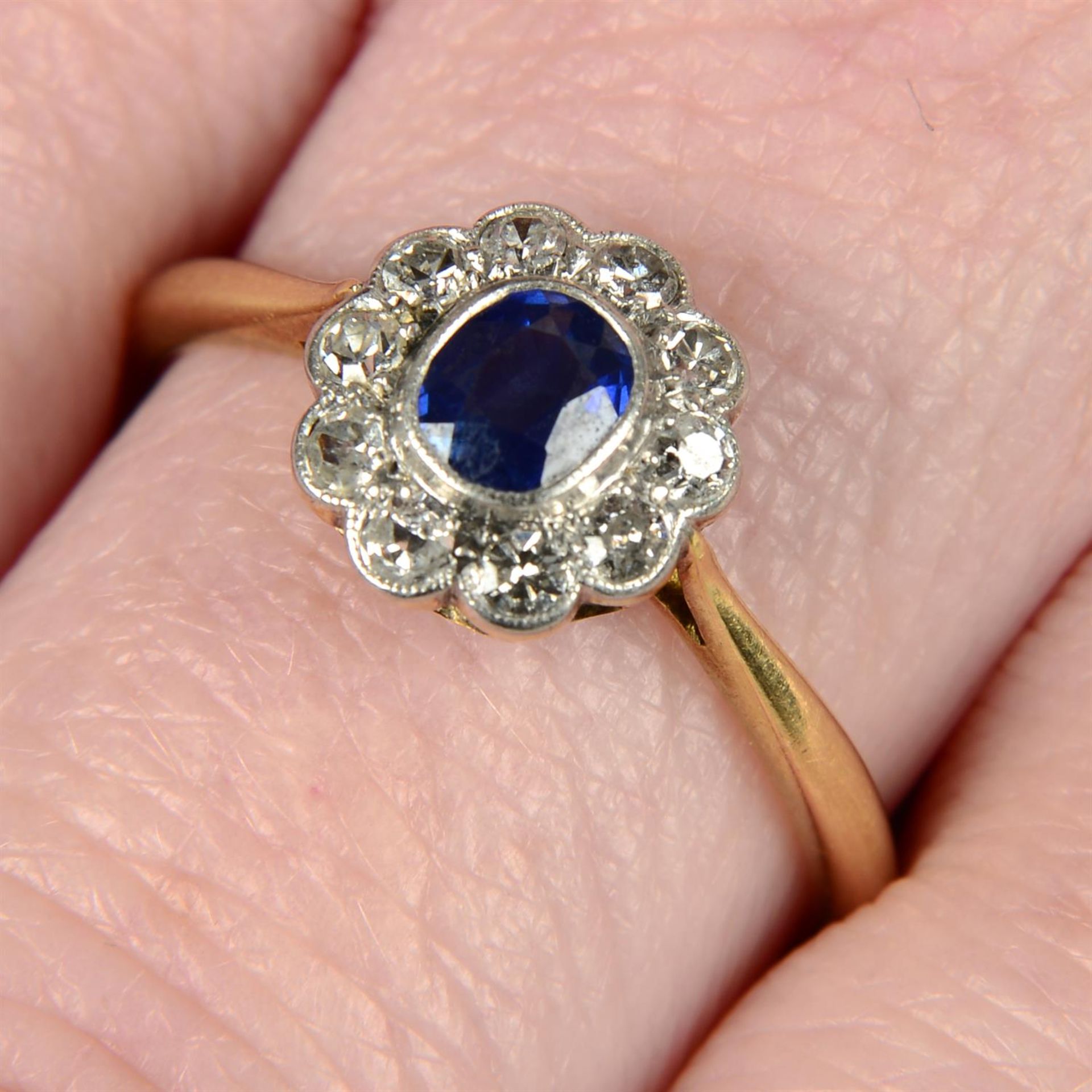 An early 20th century platinum and 18ct gold sapphire and single-cut diamond cluster ring.