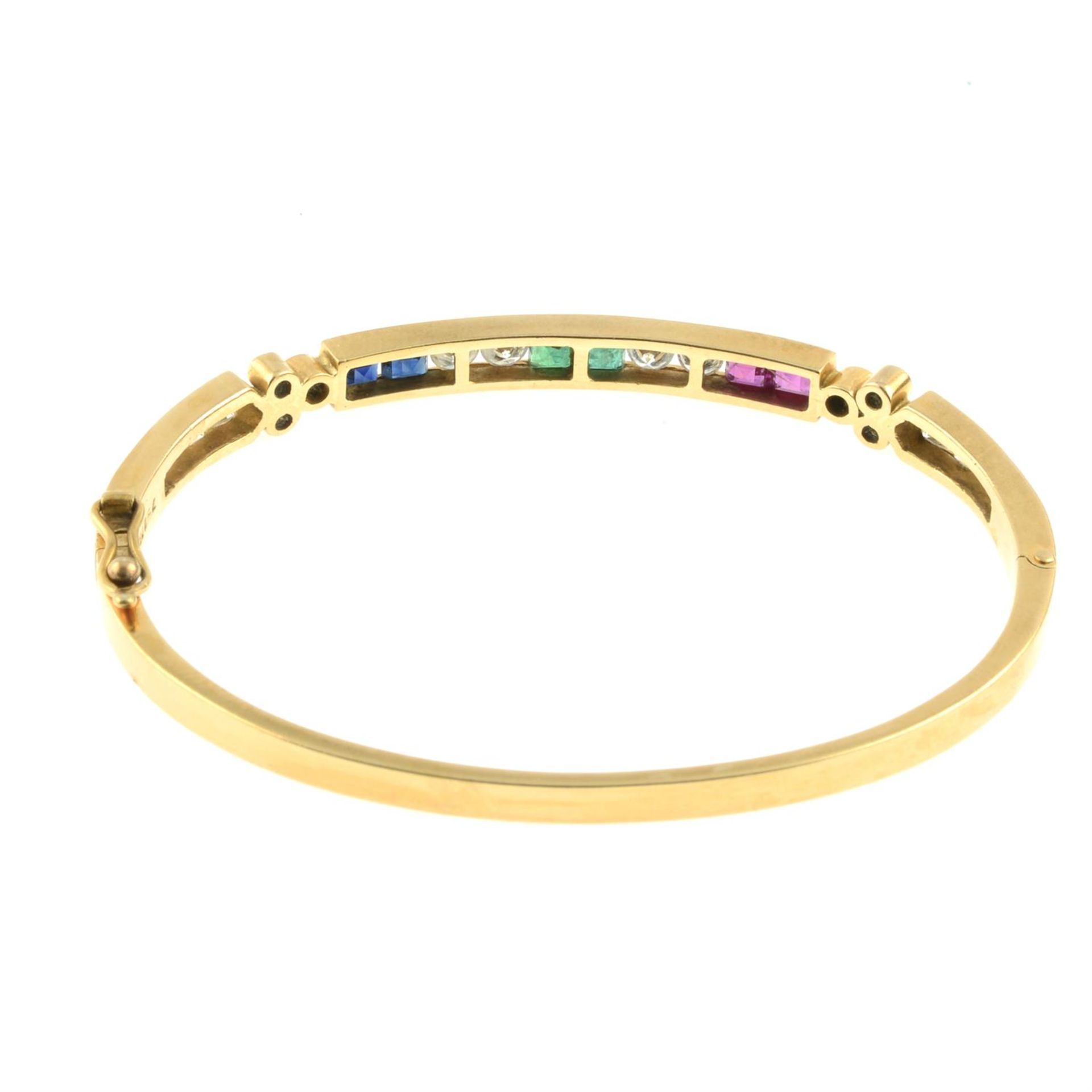 An 18ct gold brilliant-cut diamond, sapphire, emerald and ruby hinged bangle. - Image 3 of 3