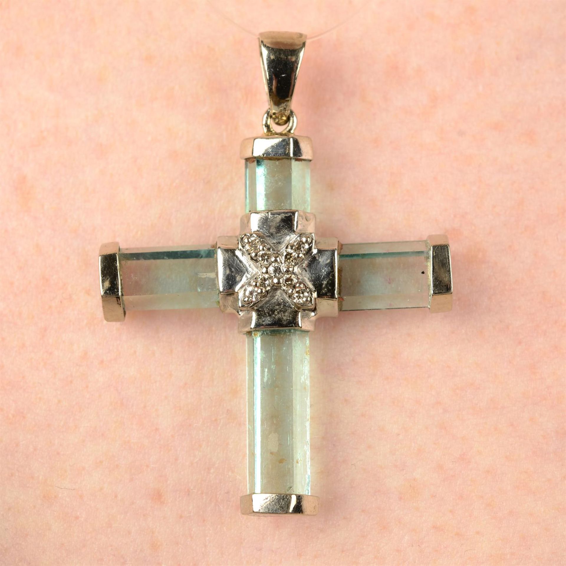 An aquamarine and diamond cross pendant.