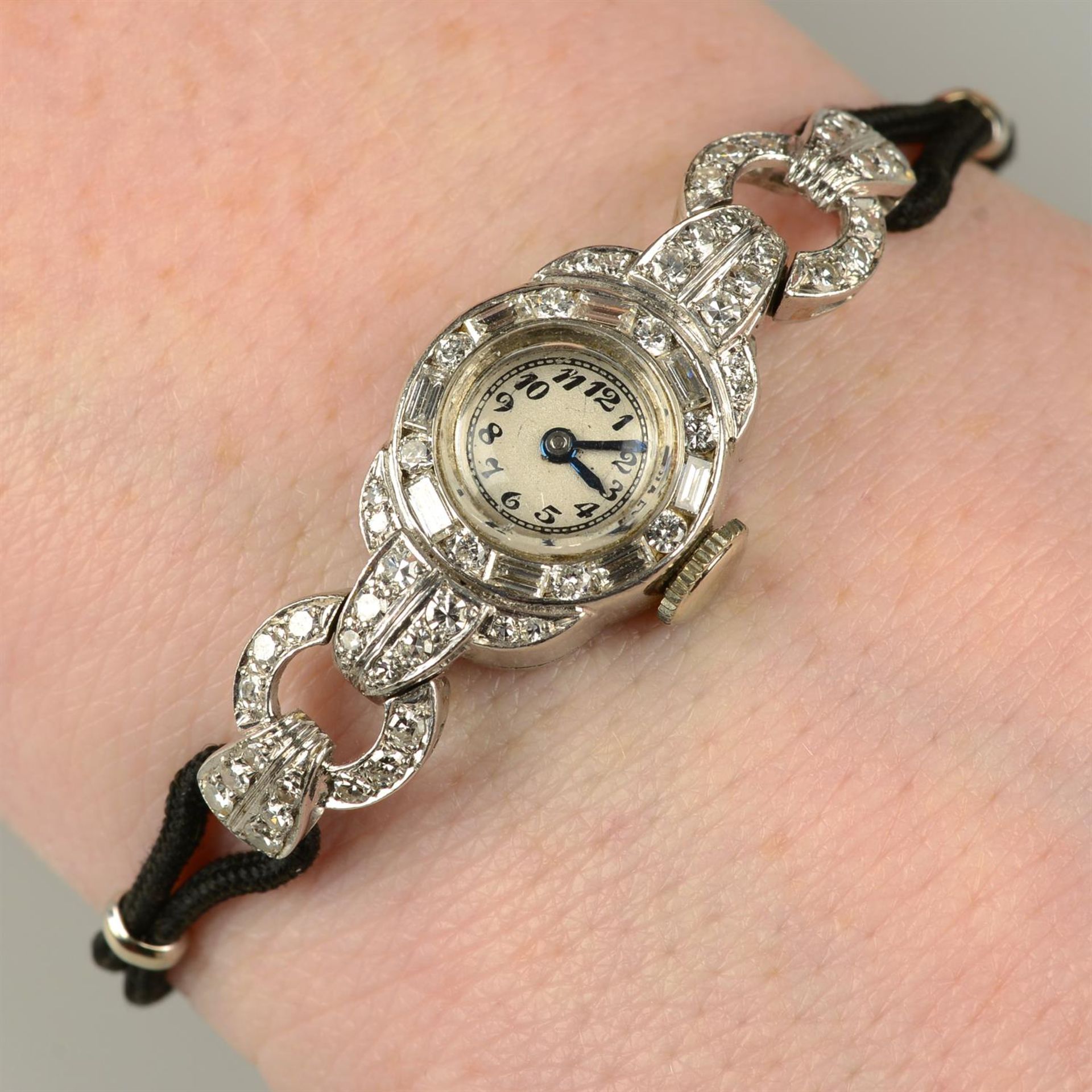 A lady's mid 20th century platinum vari-cut diamond wrist watch, by Movado.