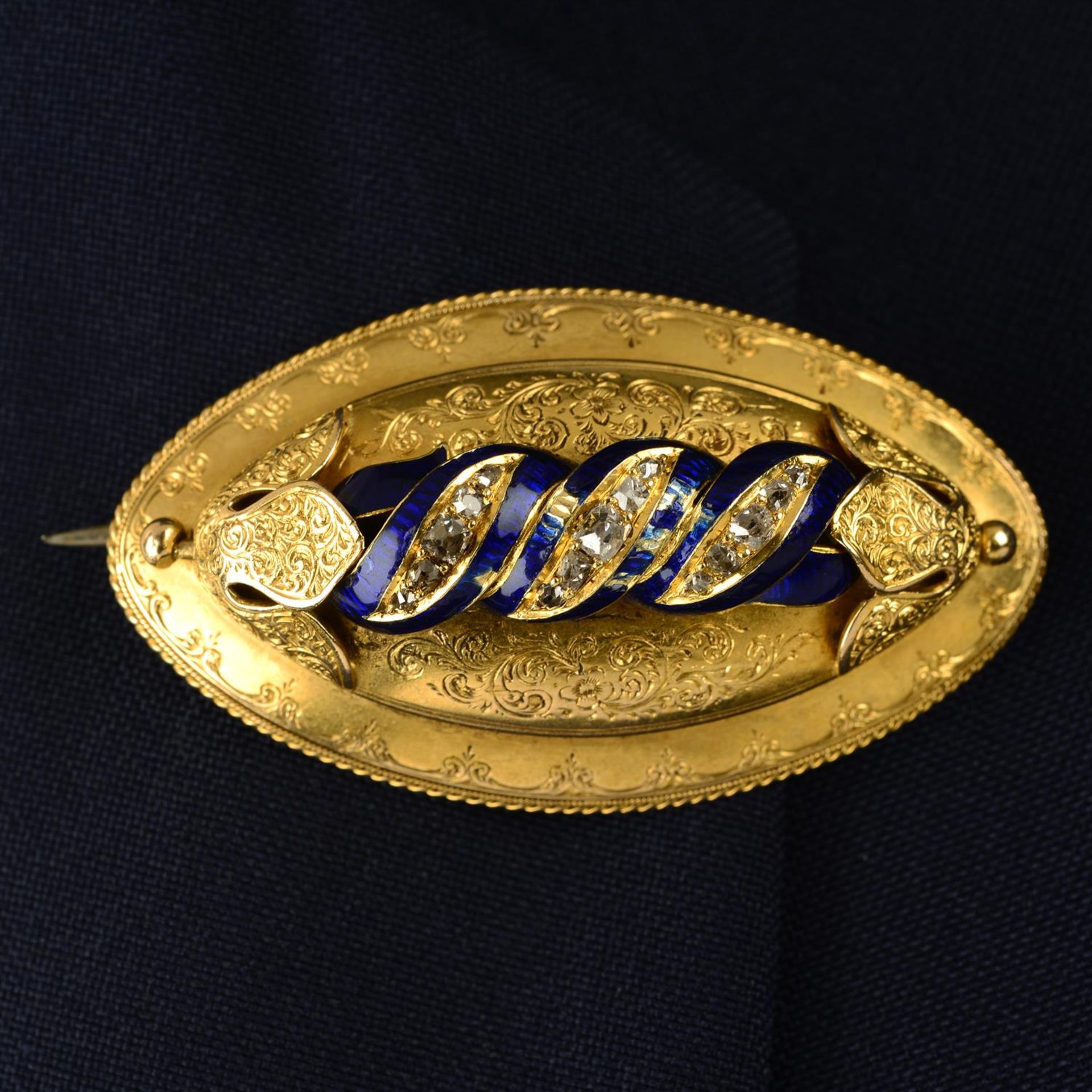 A mid to late 19th century engraved gold, old-cut diamond and blue enamel brooch.