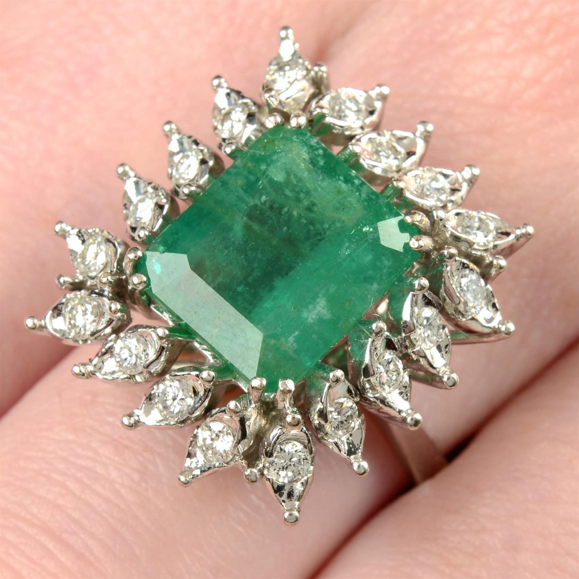 A mid 20th century 18ct gold Brazilian emerald and brilliant-cut diamond cluster ring.