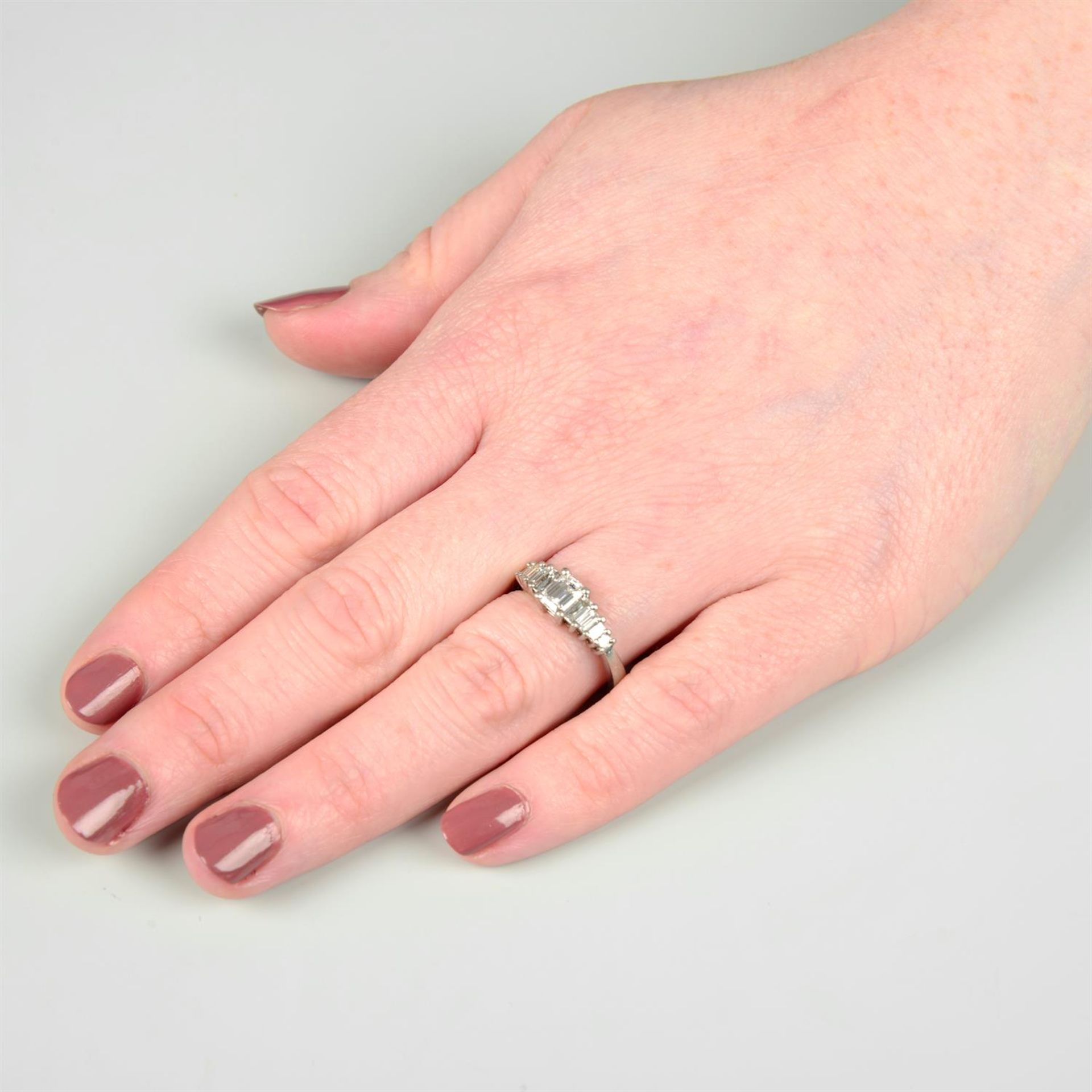 A platinum graduated baguette-cut diamond dress ring. - Image 5 of 5