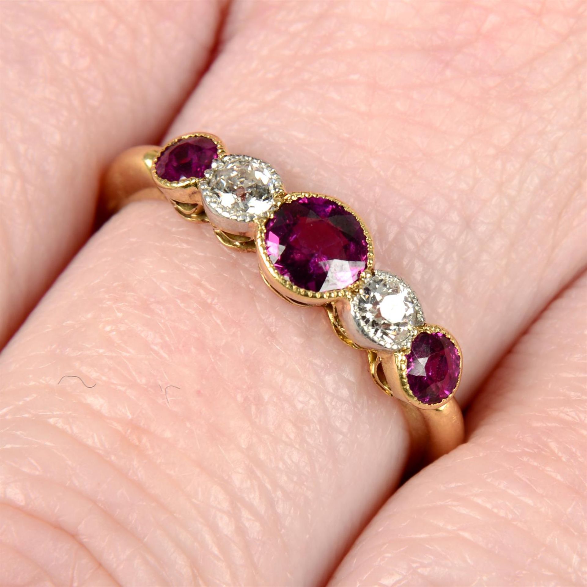 A late 19th century 18ct gold ruby and old-cut diamond five-stone ring.