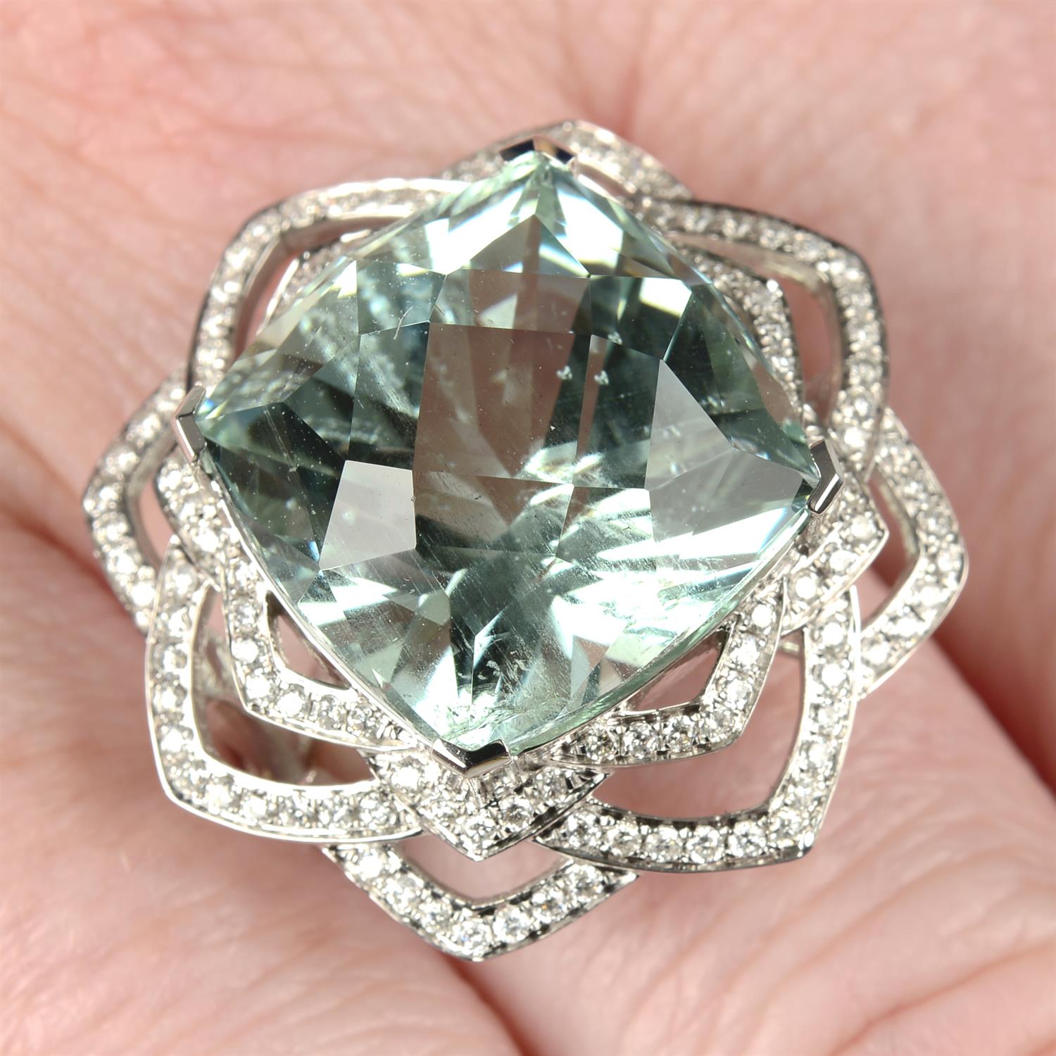An 18ct gold aquamarine and brilliant-cut diamond floral openwork ring.