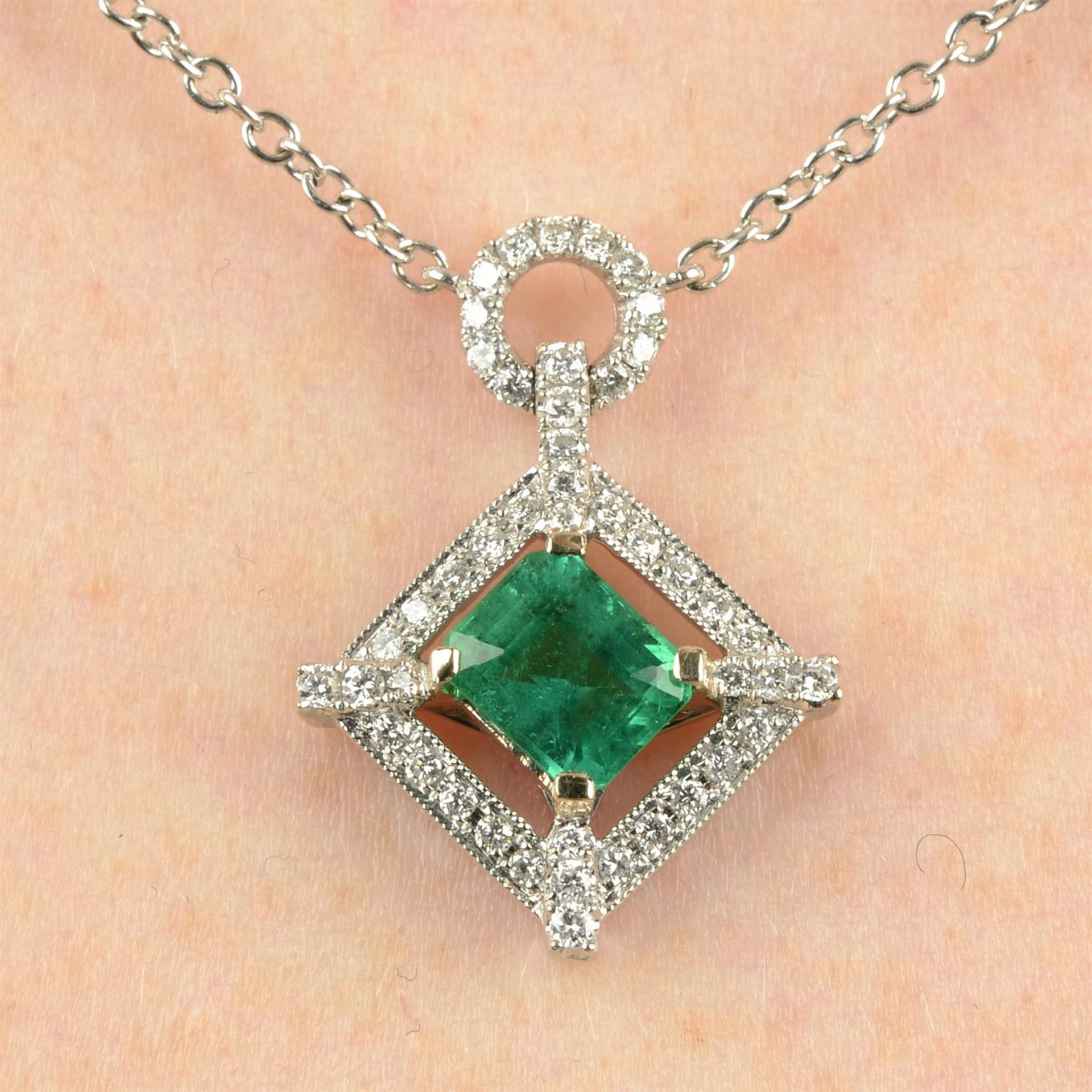 An 18ct gold emerald and brilliant-cut diamond pendant necklace.