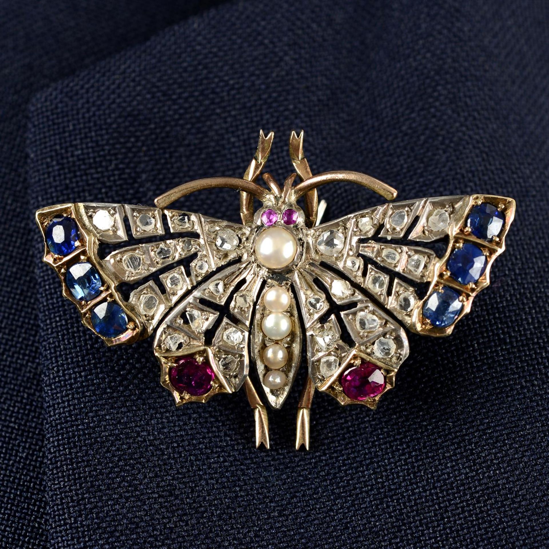 A late Victorian silver and gold, sapphire, ruby, split pearl and rose-cut diamond butterfly