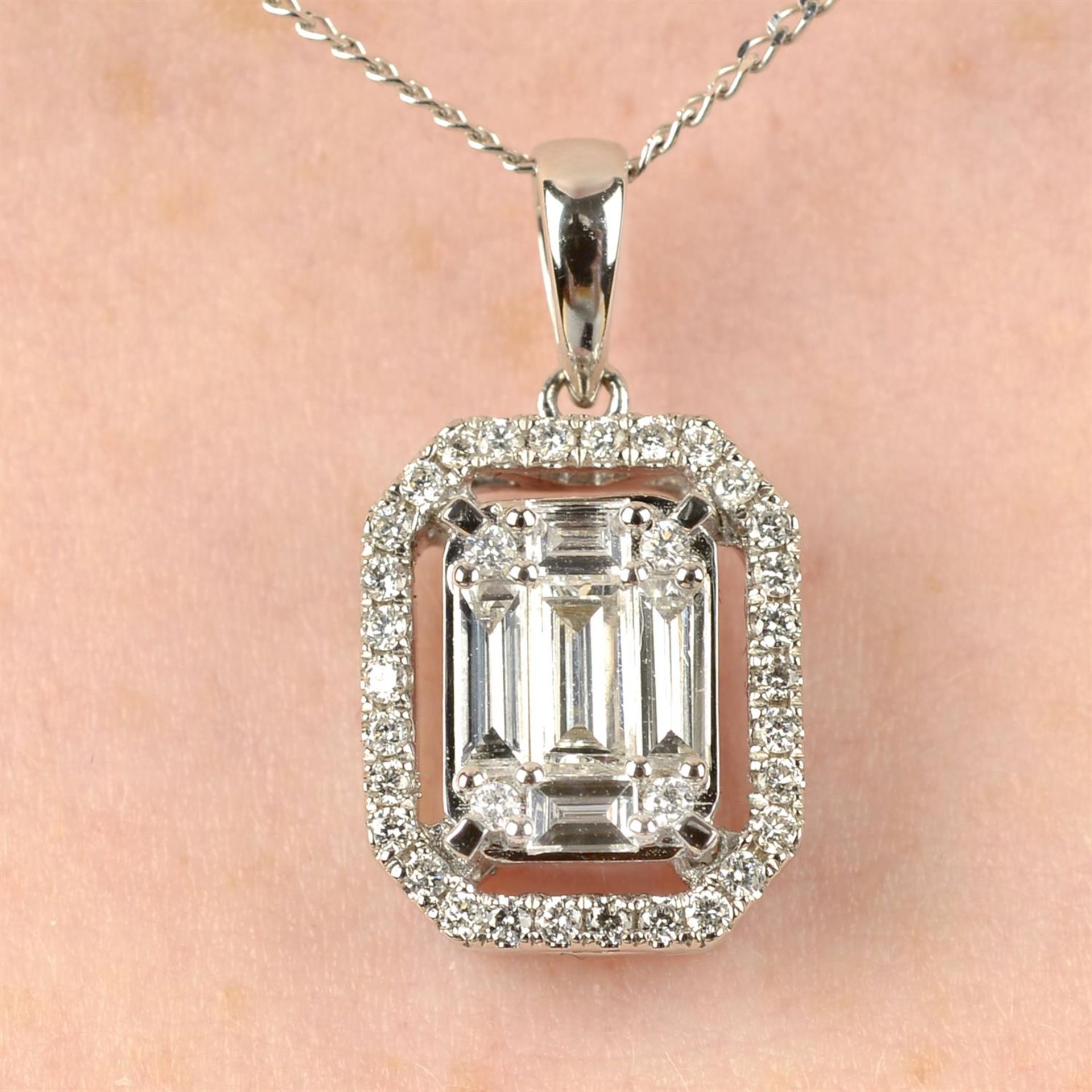 An 18ct gold diamond pendant, with chain.