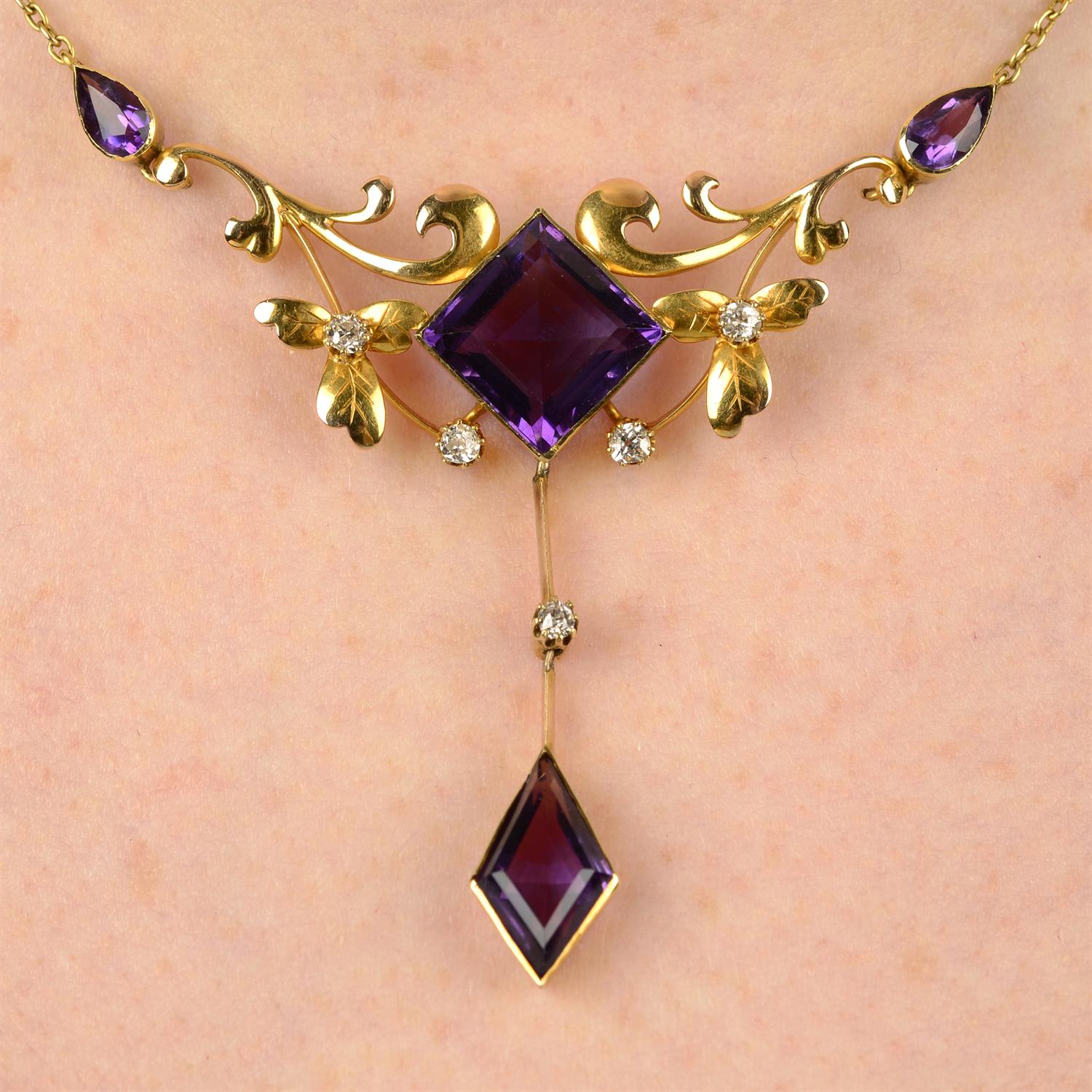 An early 20th century 15ct gold amethyst and old-cut diamond foliate drop pendant,