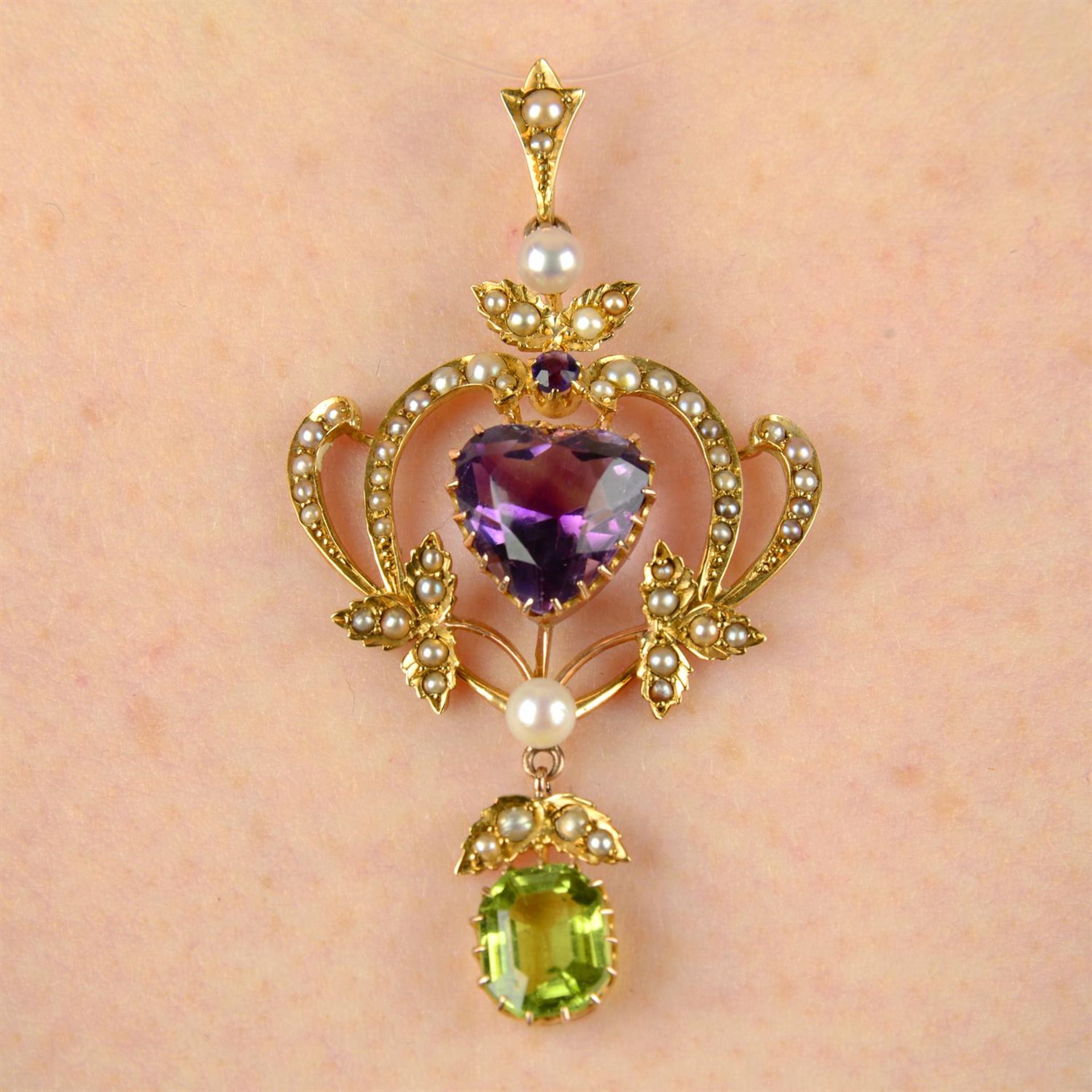 An early 20th century 15ct gold amethyst, peridot, pearl and split pearl pendant.