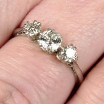 An early 20th century platinum graduated circular-cut diamond three-stone ring.