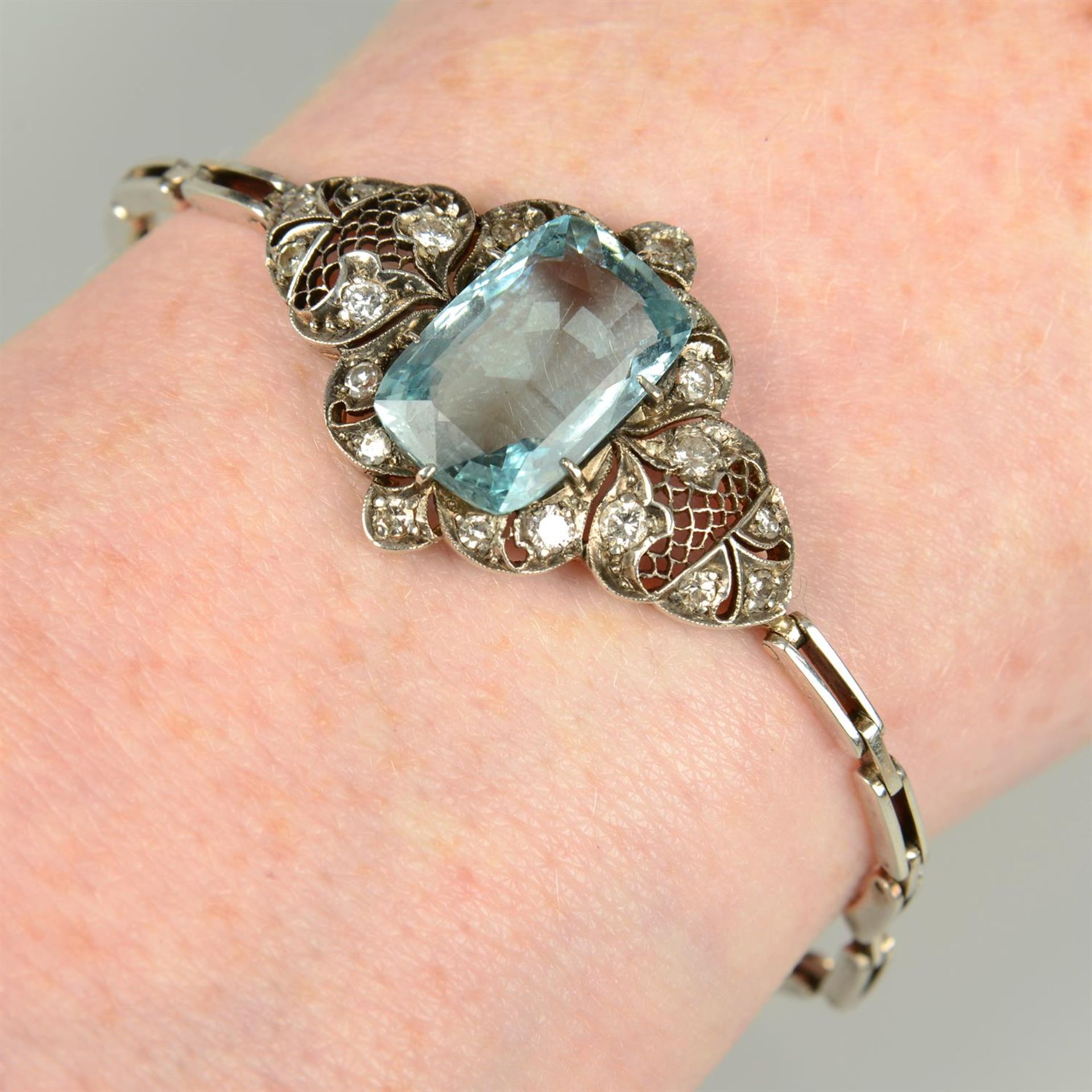 A mid 20th century silver and gold aquamarine, single and brilliant-cut diamond bracelet.