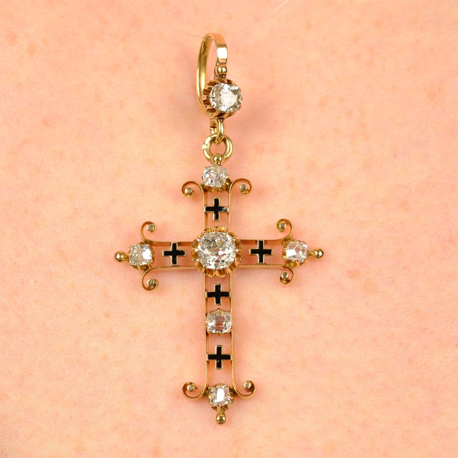 An early 20th century 18ct gold old-cut diamond and black enamel cross pendant.