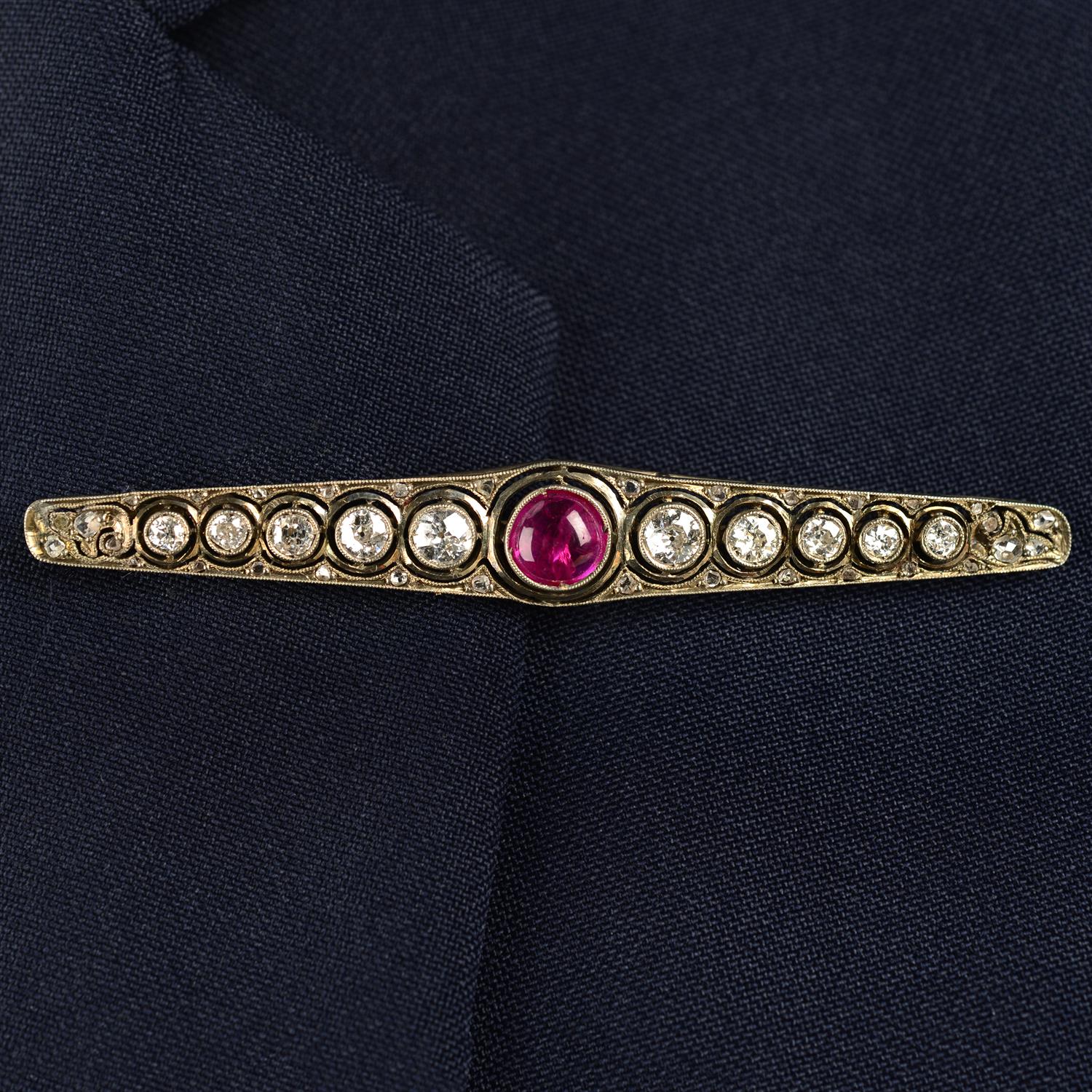 A mid 20th century silver and gold, ruby cabochon and circular-cut diamond brooch.