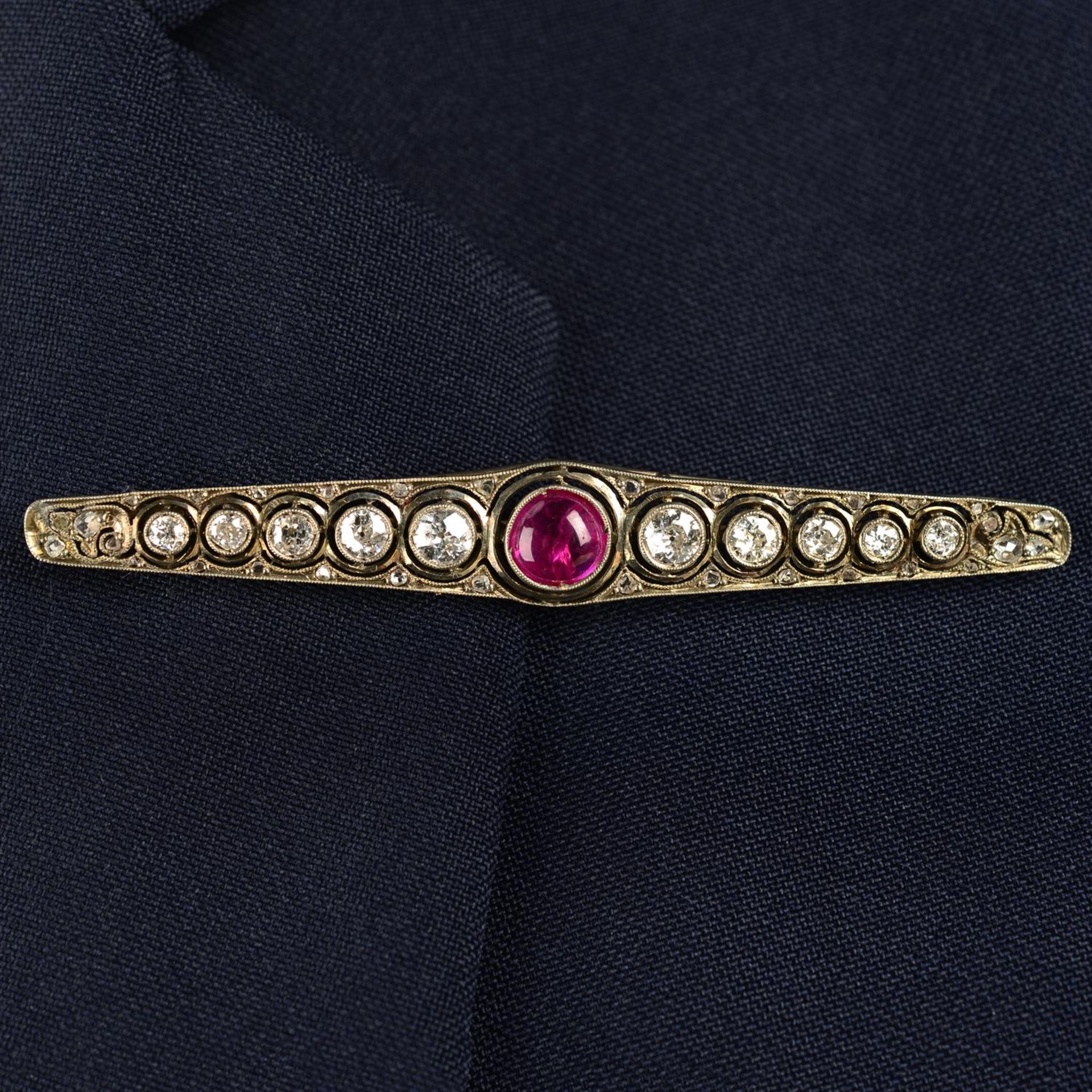 A mid 20th century silver and gold, ruby cabochon and circular-cut diamond brooch.