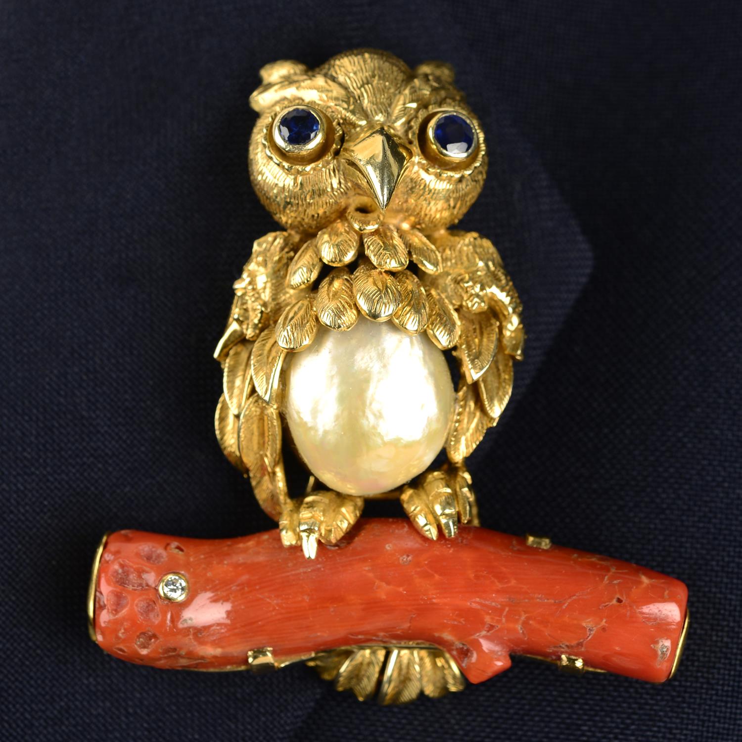 A mid 20th century 14ct gold baroque cultured pearl owl brooch, with sapphire eyes,