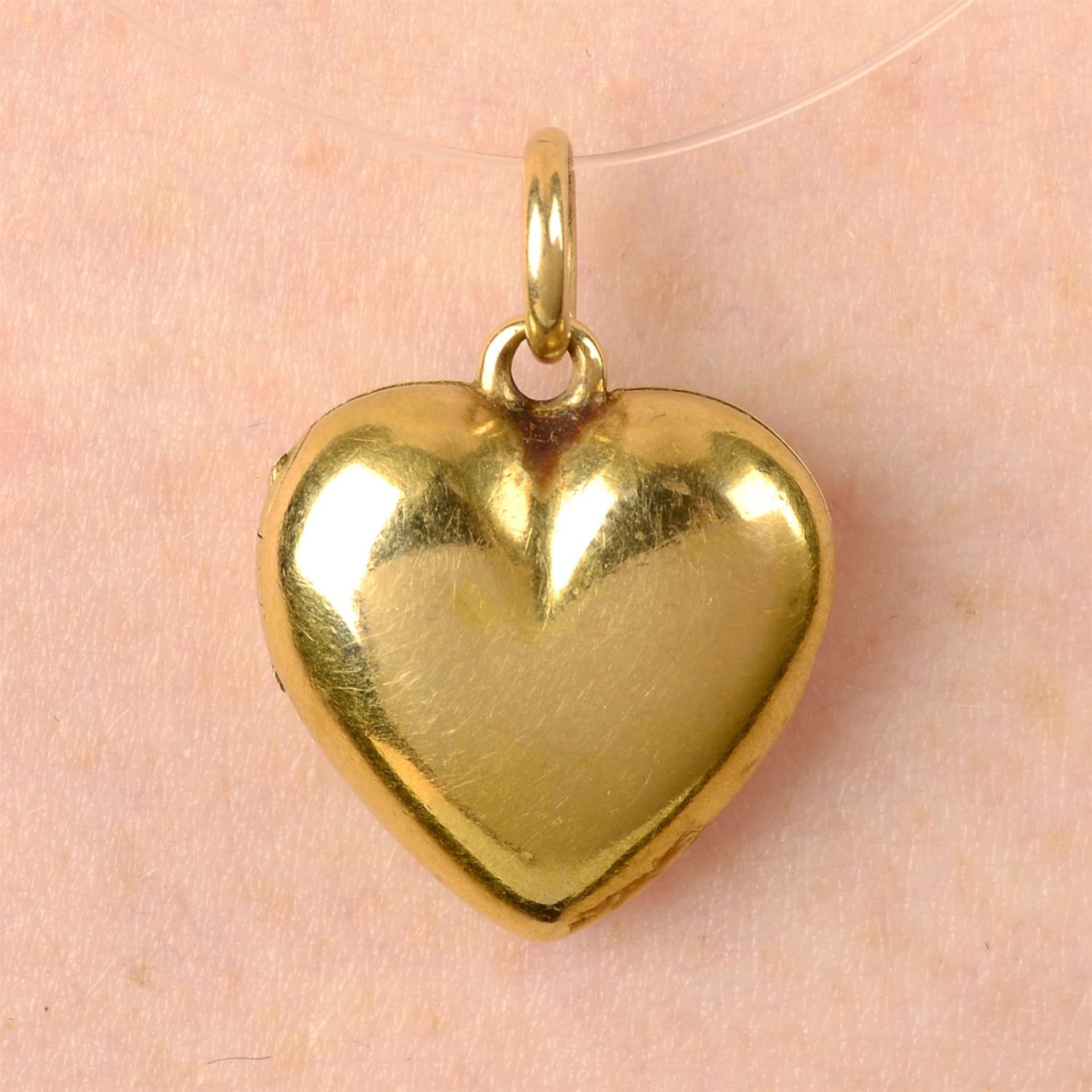 An early 20th century 18ct gold heart locket pendant.