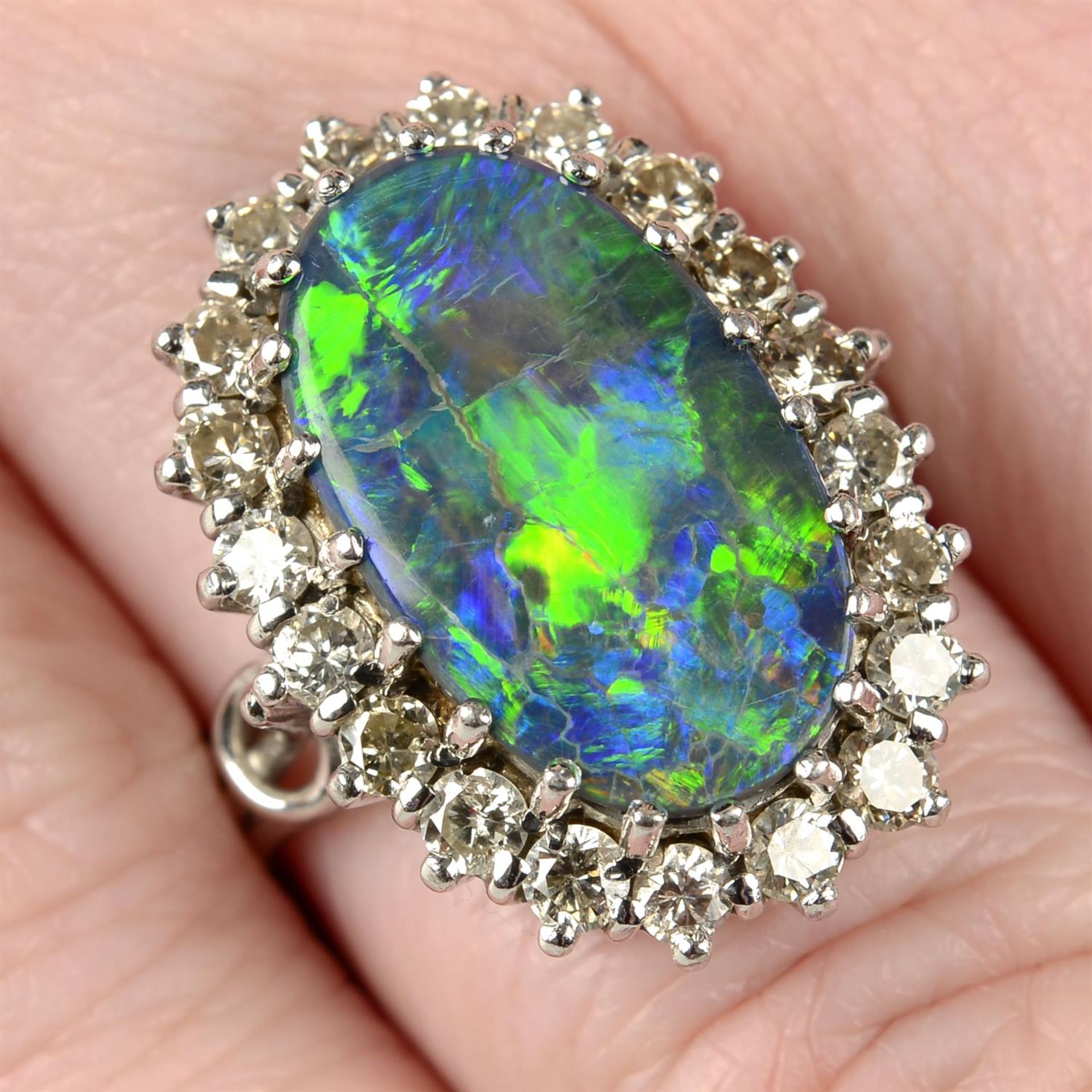 A mid 20th century platinum and 18ct gold black opal and brilliant-cut diamond cluster ring.