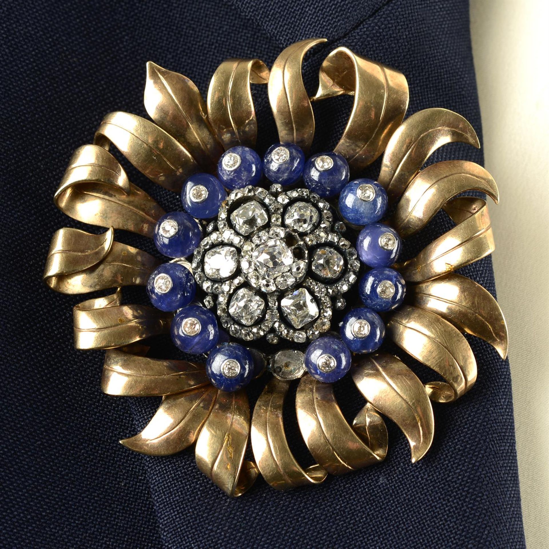 A mid 20th century silver and 9ct gold old-cut diamond and sapphire bead floral brooch.