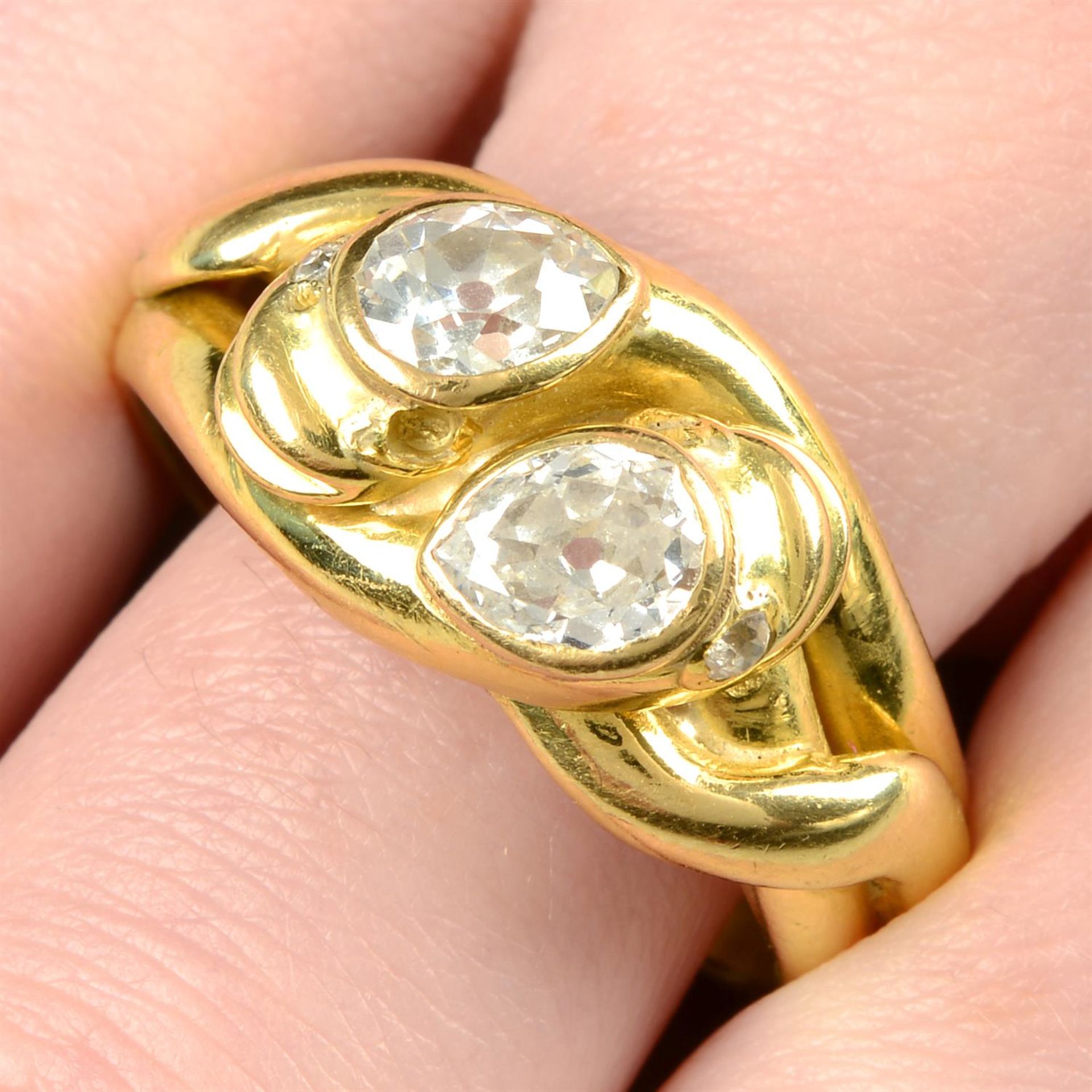 An early 20th century 18ct gold snake ring, each with pear-shape diamond crest.