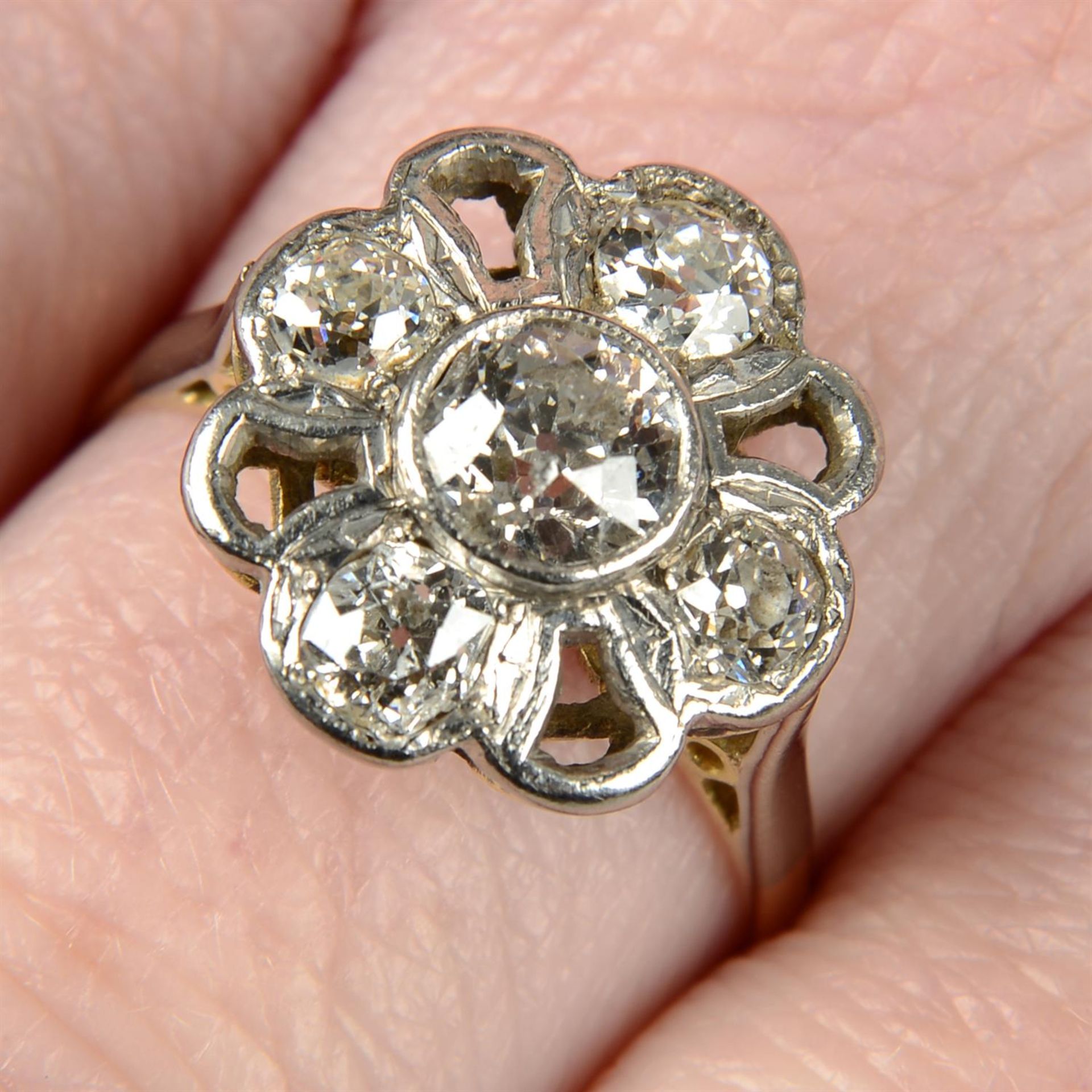 An early to mid 20th century platinum and 18ct gold old-cut diamond floral dress ring.