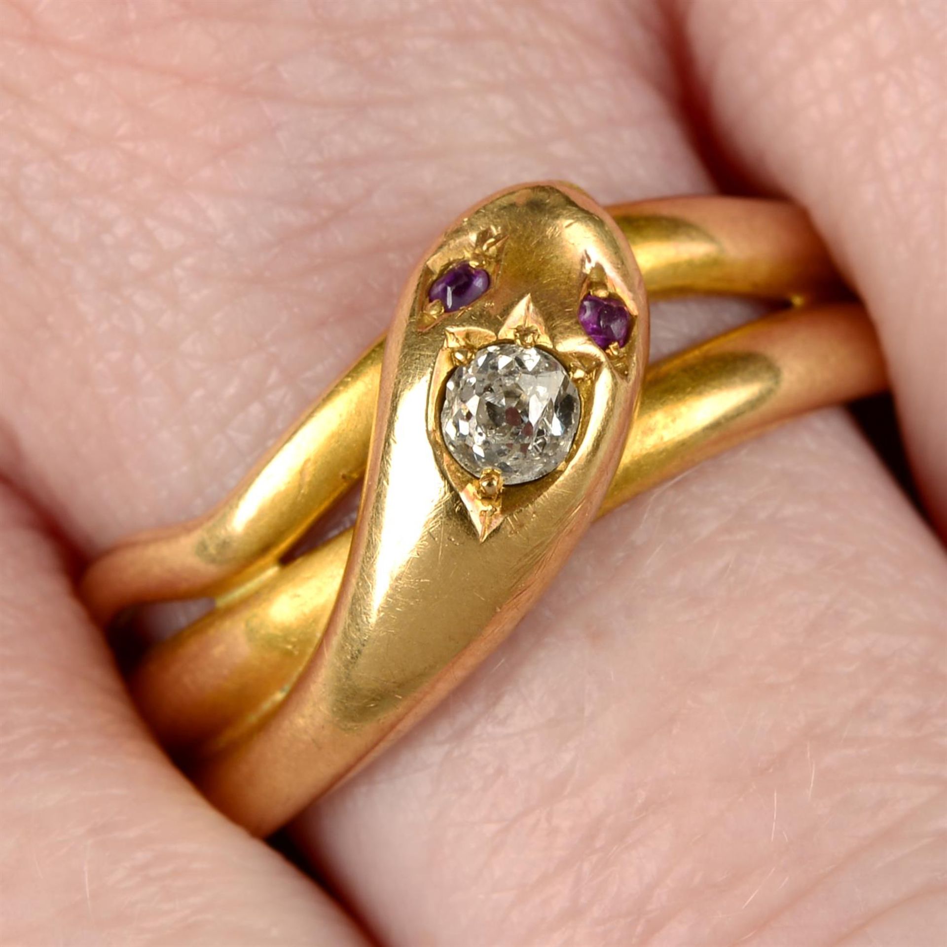 A late Victorian 18ct gold snake ring, with old-cut diamond crest and ruby eyes.