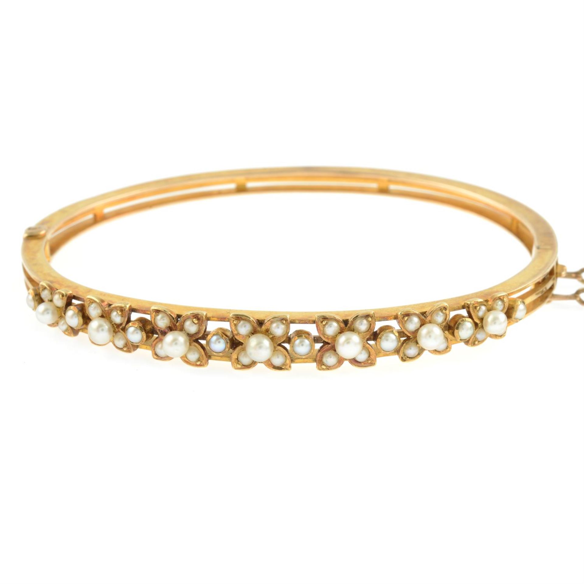 A late Victorian gold seed and split pearl floral hinged bangle. - Image 2 of 3