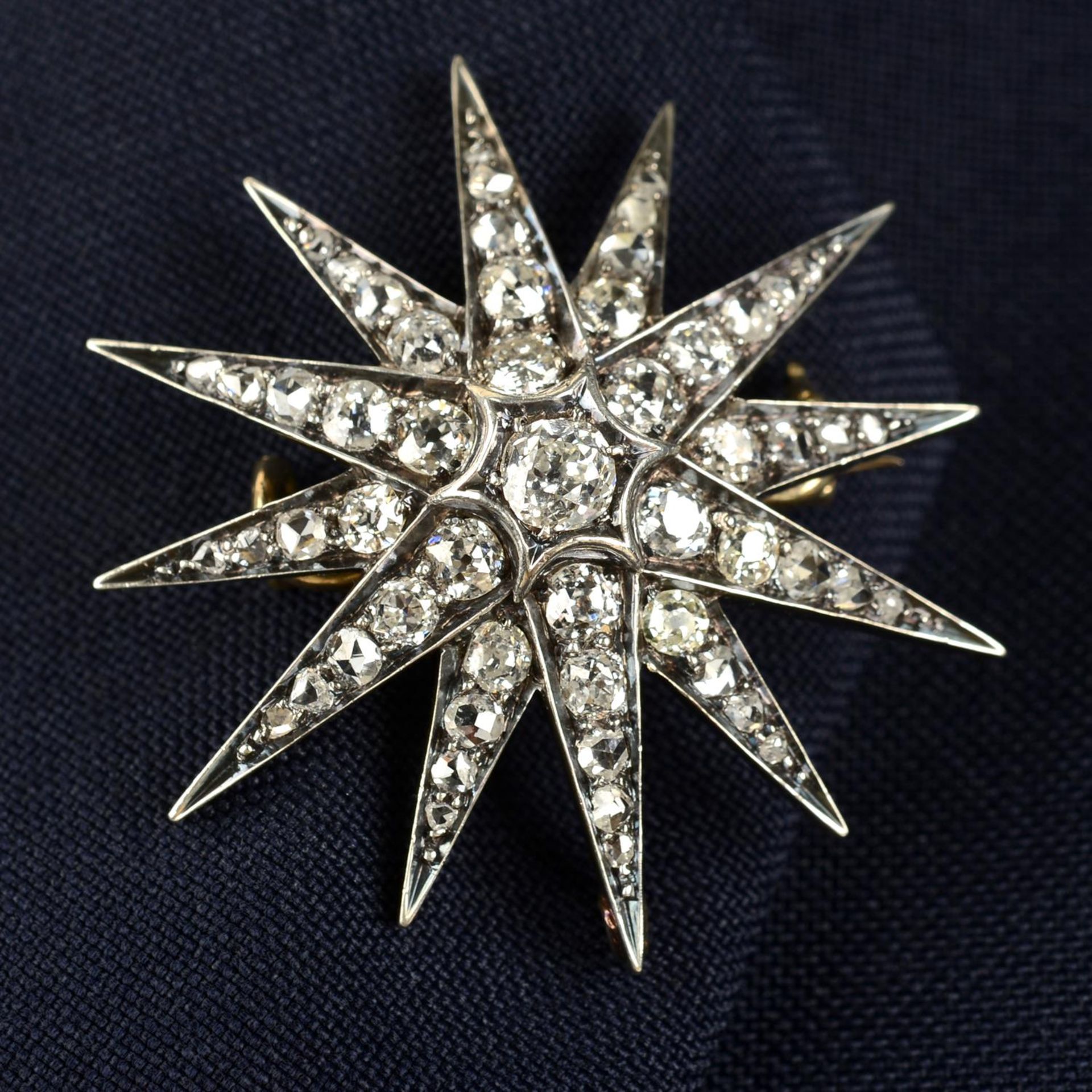 A late Victorian silver and gold old and rose-cut diamond star brooch.