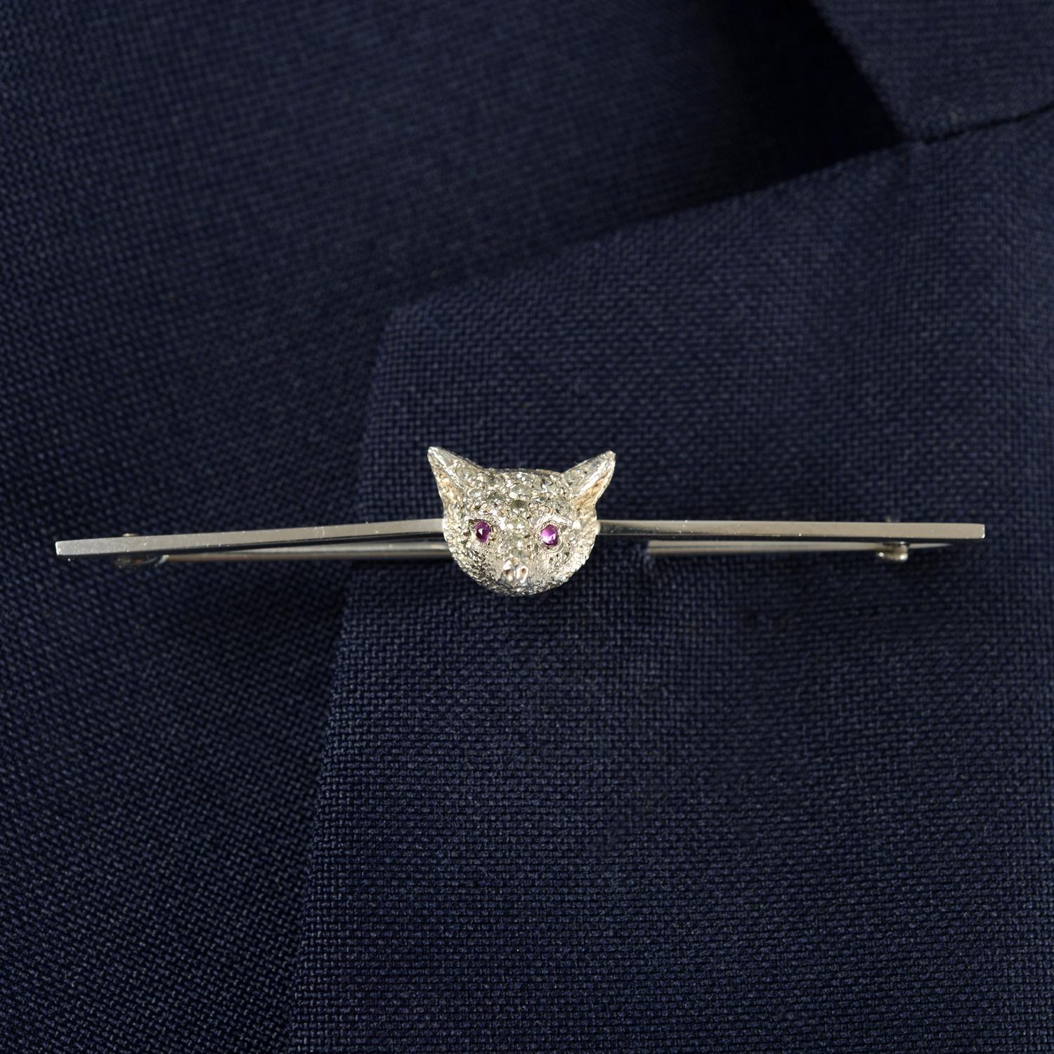 An early to mid 20th century 18ct gold single-cut diamond fox mask bar brooch, with ruby eyes.