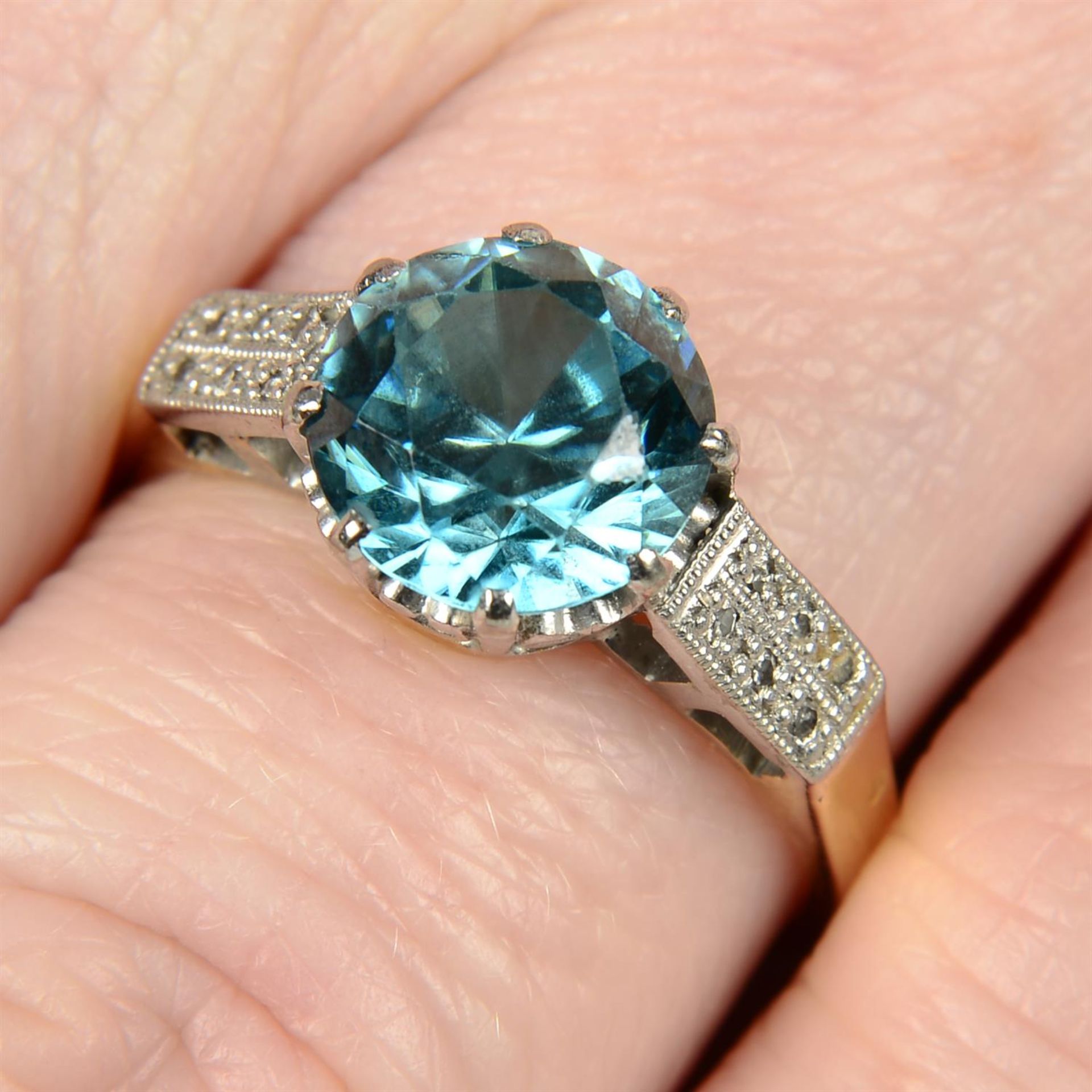 An early to mid 20th century platinum and 18ct gold blue zircon ring, with single-cut diamond bar